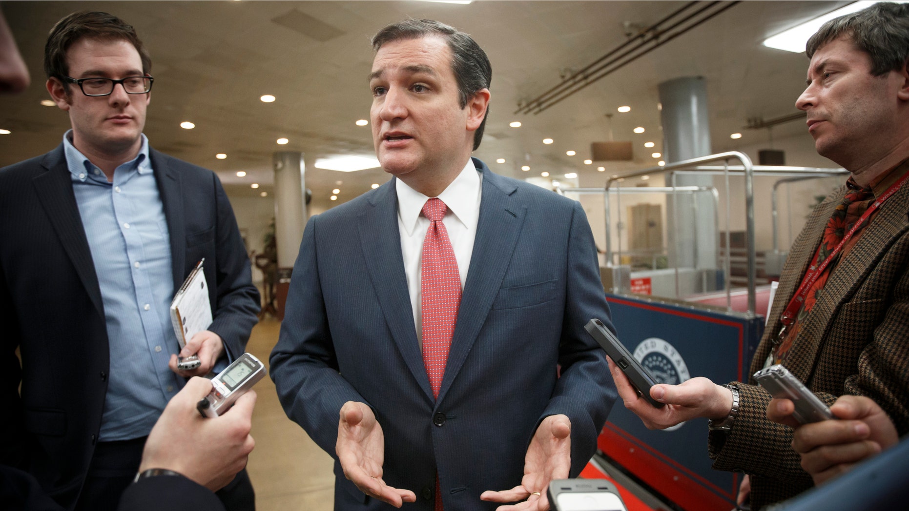 Sen. Ted Cruz, R-Texas, speaks with reporters as he arrives at the Capitol for the Senate vote to approve a $1.1 trillion spending package, the Omnibus Appropriations Act, a bipartisan compromise that all but banishes the likelihood of an election-year government shutdown, at the Capitol in Washington, Thursday, Jan. 16, 2014. The legislation is a follow-up to the budget compromise the two parties pushed through Congress in December that set overall spending limits for the next two years. (AP Photo/J. Scott Applewhite)