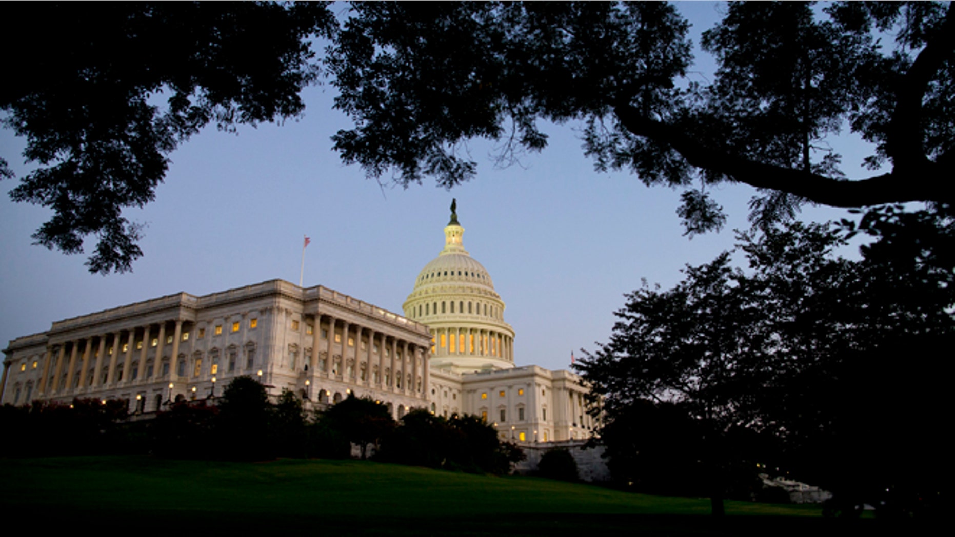 Dusk falls over the Capitol building as the budget battle continues on Monday, Sept. 30, 2013 in Washington. President Barack Obama ramped up pressure on Republicans Monday to avoid a post-midnight government shutdown, saying that failure to pass a short-term spending measure to keep agencies operating would "throw a wrench into the gears" of a recovering economy. (AP Photo/ Evan Vucci)