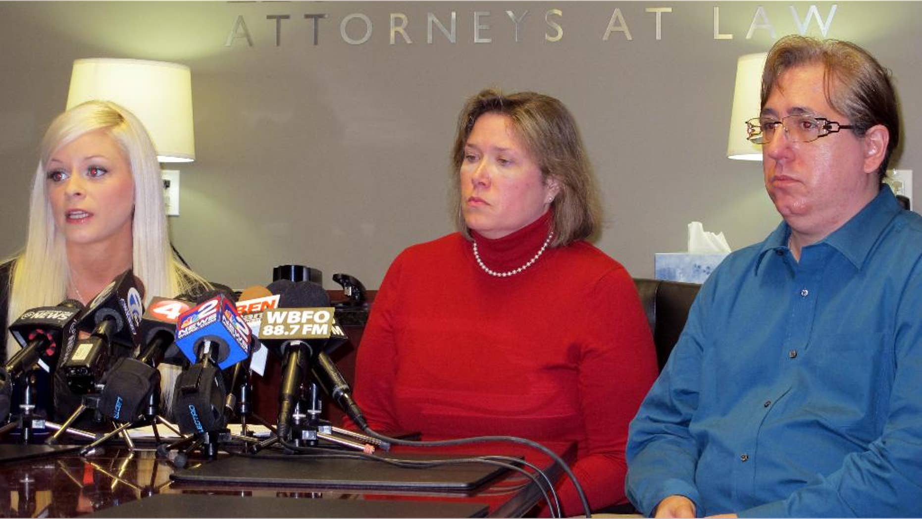 Vanessa DeRosa, left, and Antonio Flores, right, along with their attorney Diane Tiveron, center, discuss their request for Pope Francis to investigate the way the Diocese of Buffalo has handled complaints of sexual abuse, during a news conference in Tiveron's office in Amherst, N.Y., on Tuesday, Jan. 27, 2015. DeRosa and Flores say they were victimized as teenagers by employees of the diocese, which had no immediate comment. (AP Photo/Carolyn Thompson)