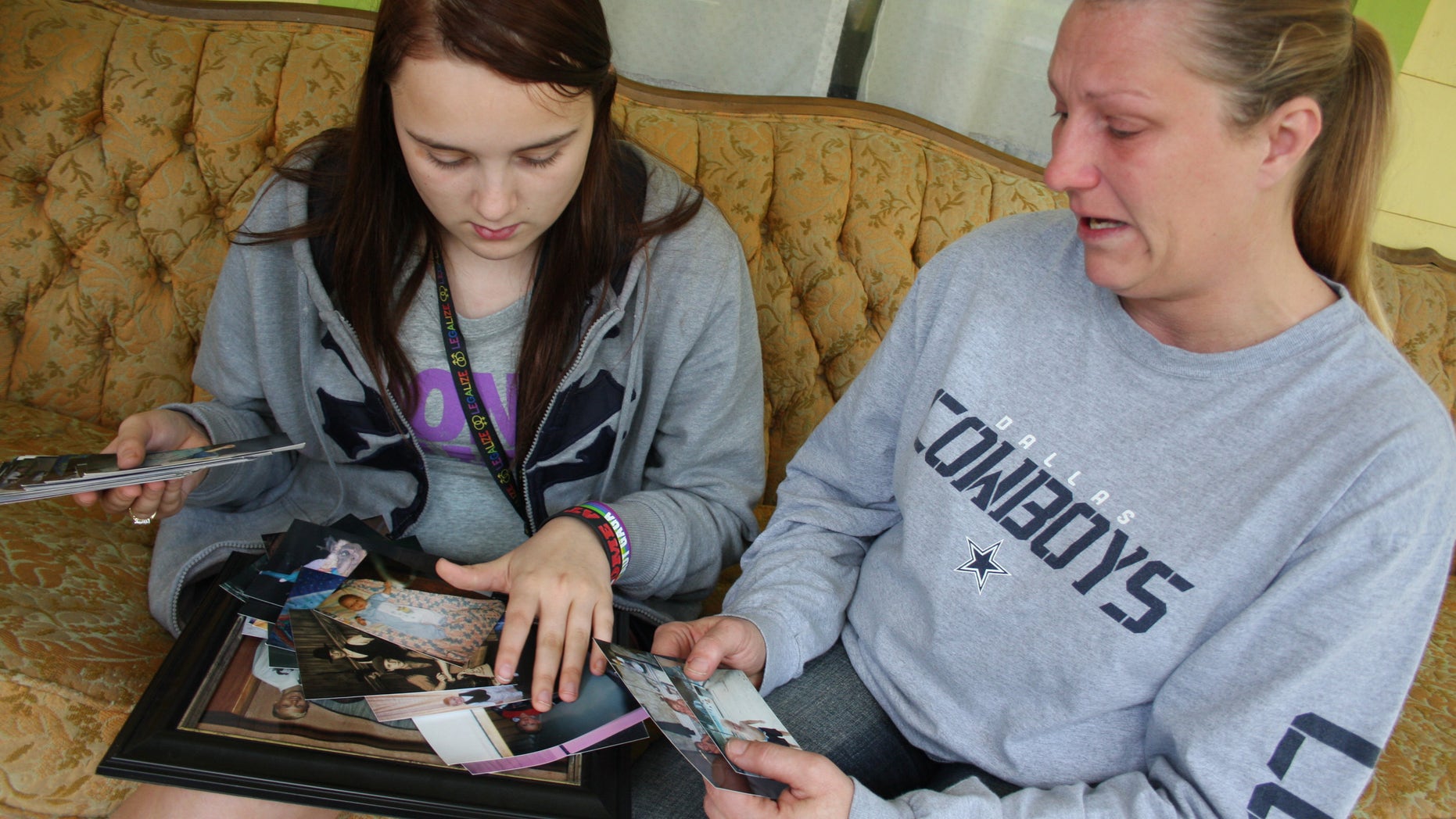 April 17: Kenneth Weishuhn's sister, Kayla Weishuhn, 16, and his mother, Jeannie Chambers, look at photos of Kenneth, 14, who committed suicide Sunday, April 15, 2012, at their home Primghar, Iowa.