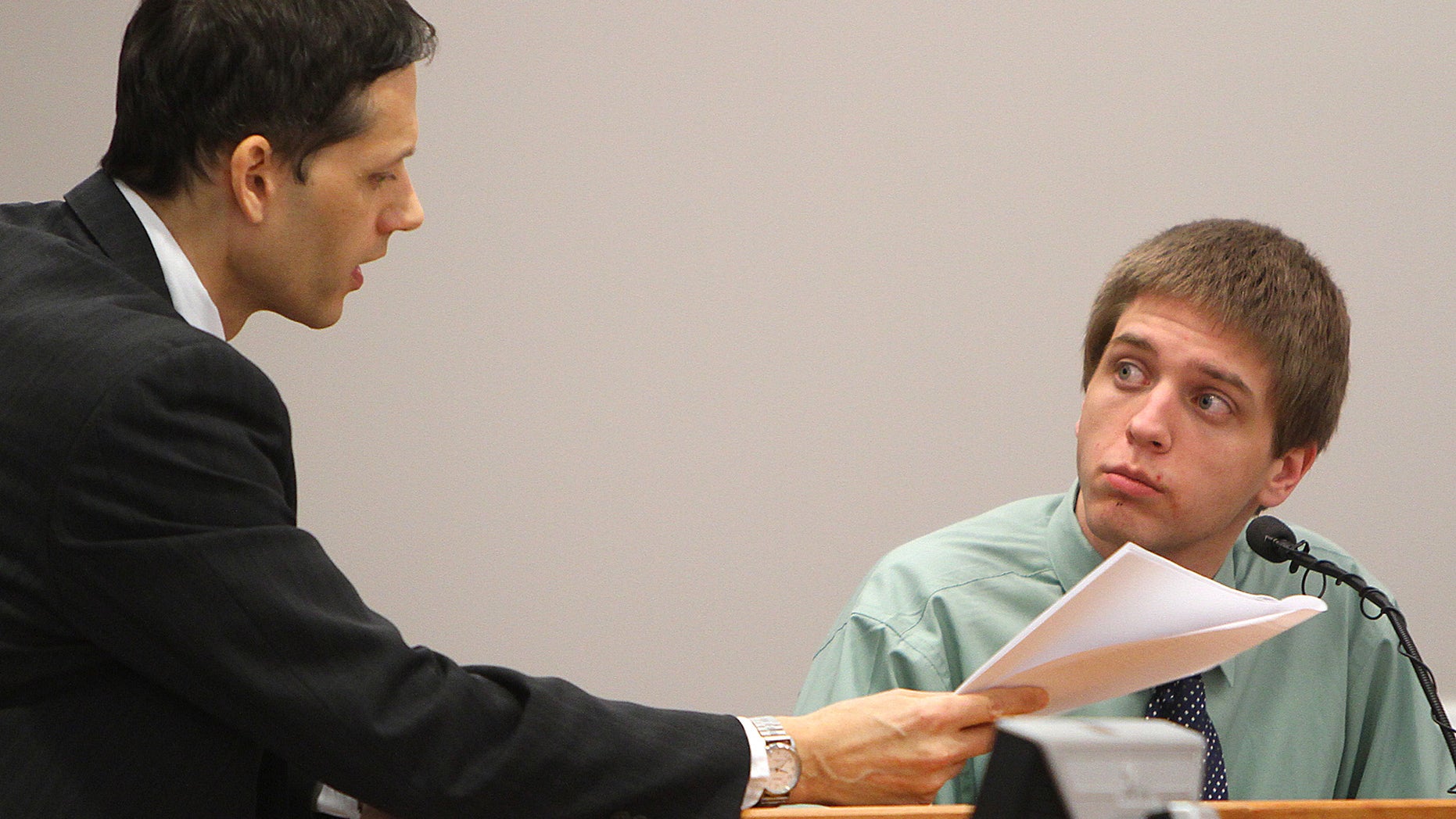 March 16: Prosecutor Jeff Strelzin shows indictments to Christopher Gribble during cross examination at Hillsborough Superior Court in Nashua, N.H. Gribble has admitted he killed Kimberly Cates and tried to kill her 11-year-old daughter, Jaimie, in their Mont Vernon home but claims he was insane at the time.