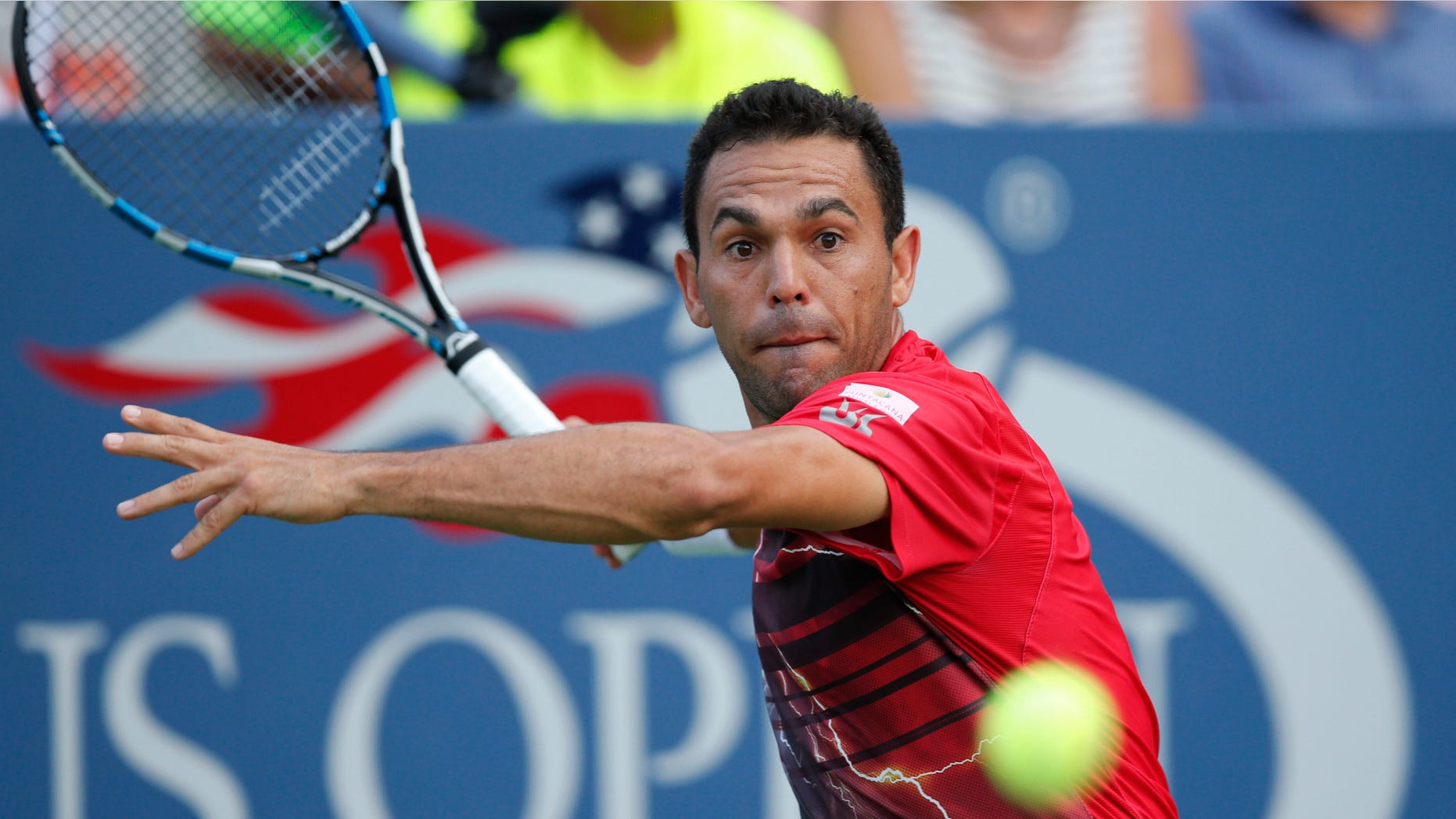 Victor Estrella Burgos, of the Dominican Republic, returns the ball during his first-round match against Jack Sock, of the United States, at the U.S. Open tennis tournament in New York, Tuesday, Sept. 1, 2015. (AP Photo/Kathy Willens)