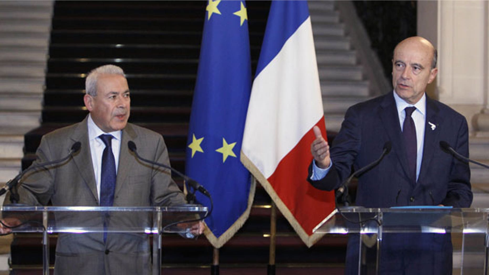 November 23, 2011: French Foreign Minister Alain Juppe, right, and Burhan Ghalioun, the head of the Syrian National Council opposition group addresses reporters during a news conference following their meeting in Paris.