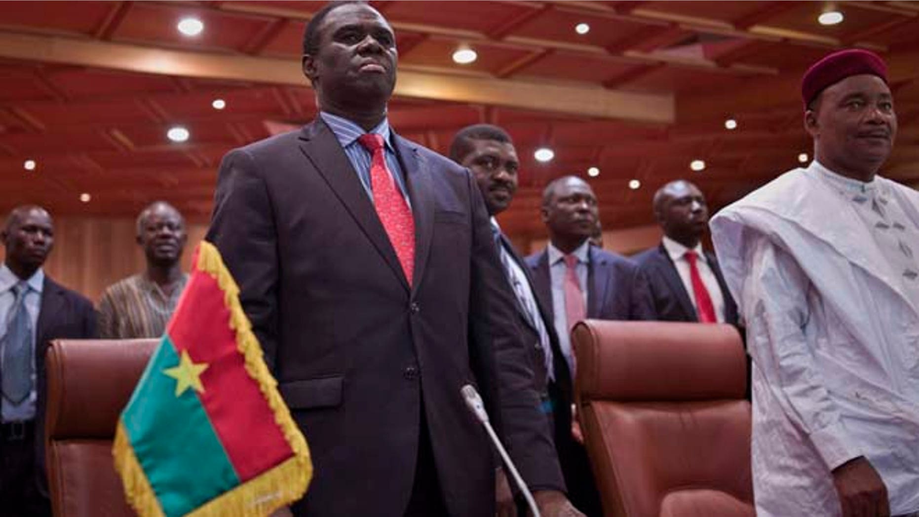 Sept. 23, 2015: Burkina Faso's transitional president Michel Kafando, left, next to Niger's President, Mahamadou Issoufou, right, during a official handover ceremony in Ouagadougou, Burkina Faso.