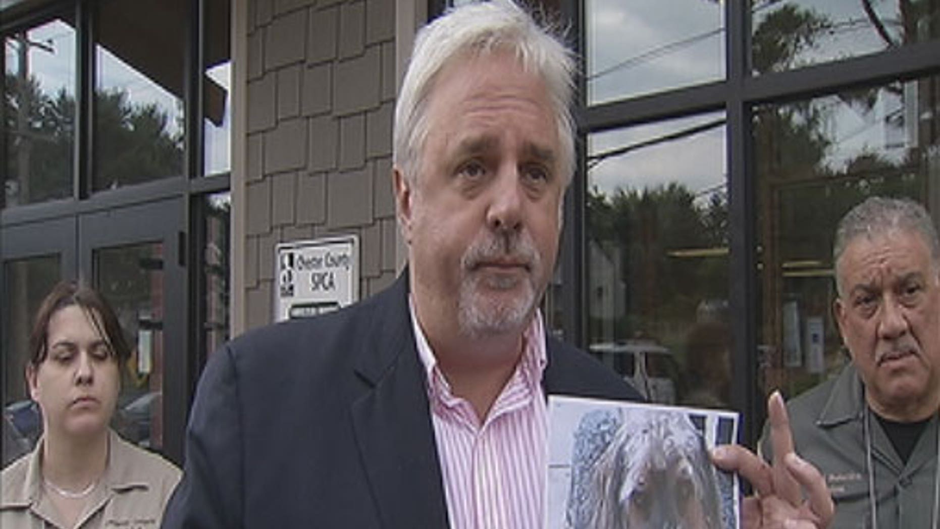 June 9, 2012: Officials from the Chester County SPCA hold up a photo of a dog similar to one found set on fire in Coatesville early Saturday.