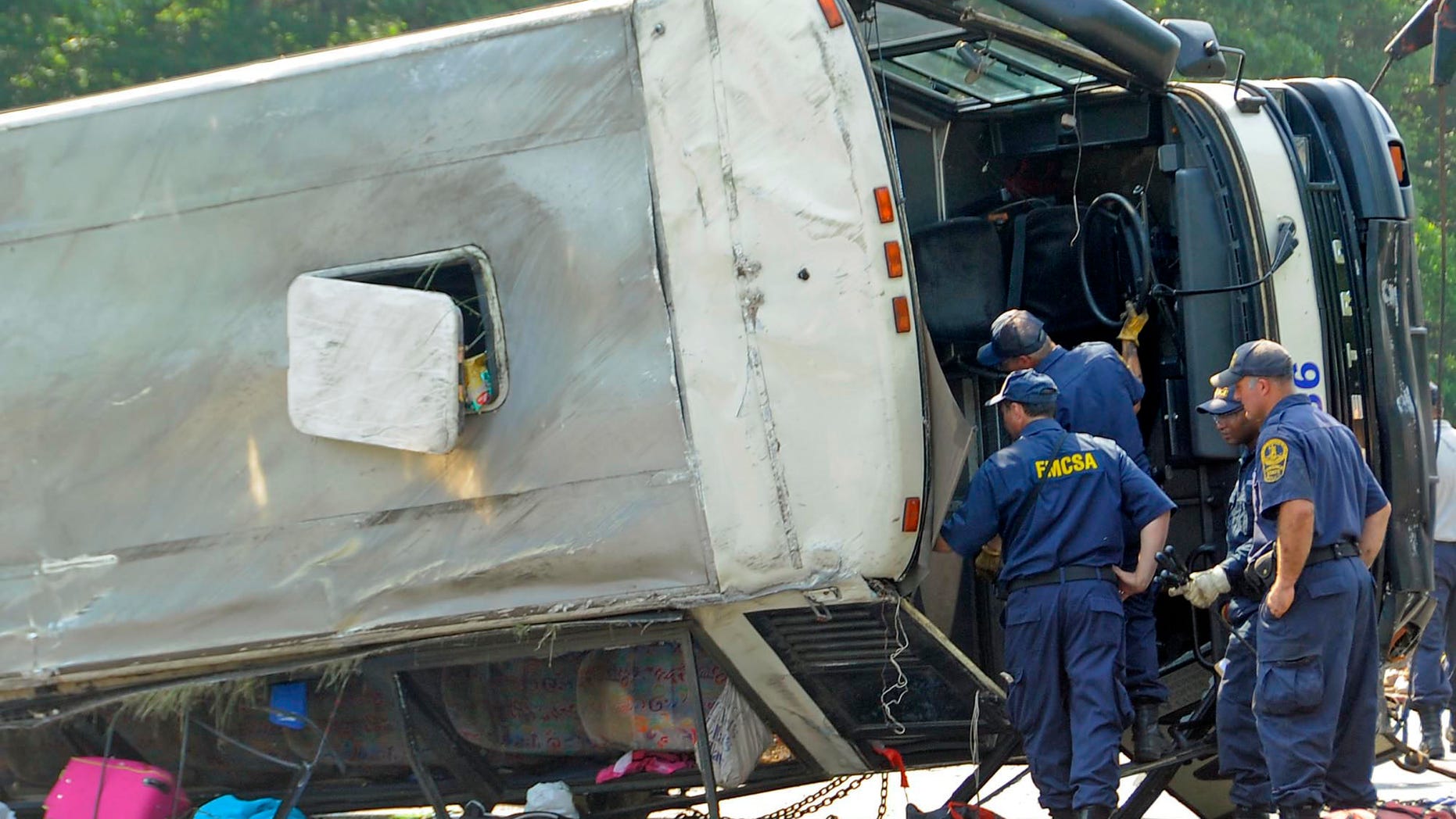 May 31: The Virginia State Police Accident Reconstruction Team and Motor Carrier Safety Team inspect a bus that was involved in a single-vehicle accident in Bowling Green, Va. The commercial tour bus went off Interstate 95 in Virginia and flipped on its roof before dawn Tuesday, killing four people and injuring many more, state police said. (AP/The Free Lance-Star)