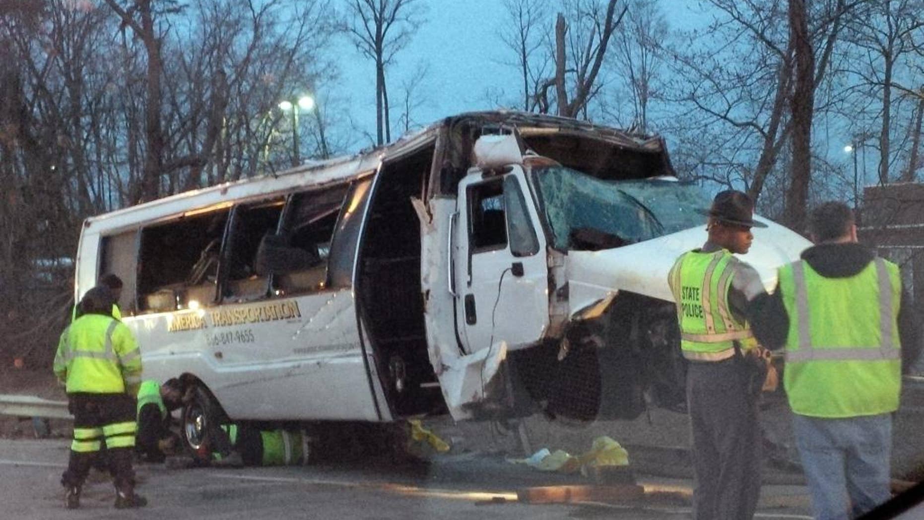 This photo provided by the Virginia State Police, police investigate the scene of a bus accident on Interstate 95, early Sunday, March 23, 2014 in Fairfax County, Va. The shuttle bus struck a guardrail and overturned before dawn Sunday just south of the nation's capital, leaving at least one person dead and sending 16 others to the hospital, Virginia State Police said. The bus was headed south on the heavily traveled East Coast artery when witnesses reported a white, speeding four-door passenger vehicle swerved into the bus's travel lane. The bus then swerved to the right to avoid the sedan, ran off the road, struck the guardrail and overturned, Virginia State Police said. The crash occurred on the interstate in northern Virginia's Fairfax County and police were called at 3:28 a.m. Sunday, State Police spokeswoman Corinne Geller said. (AP Photo/Virginia State Police)