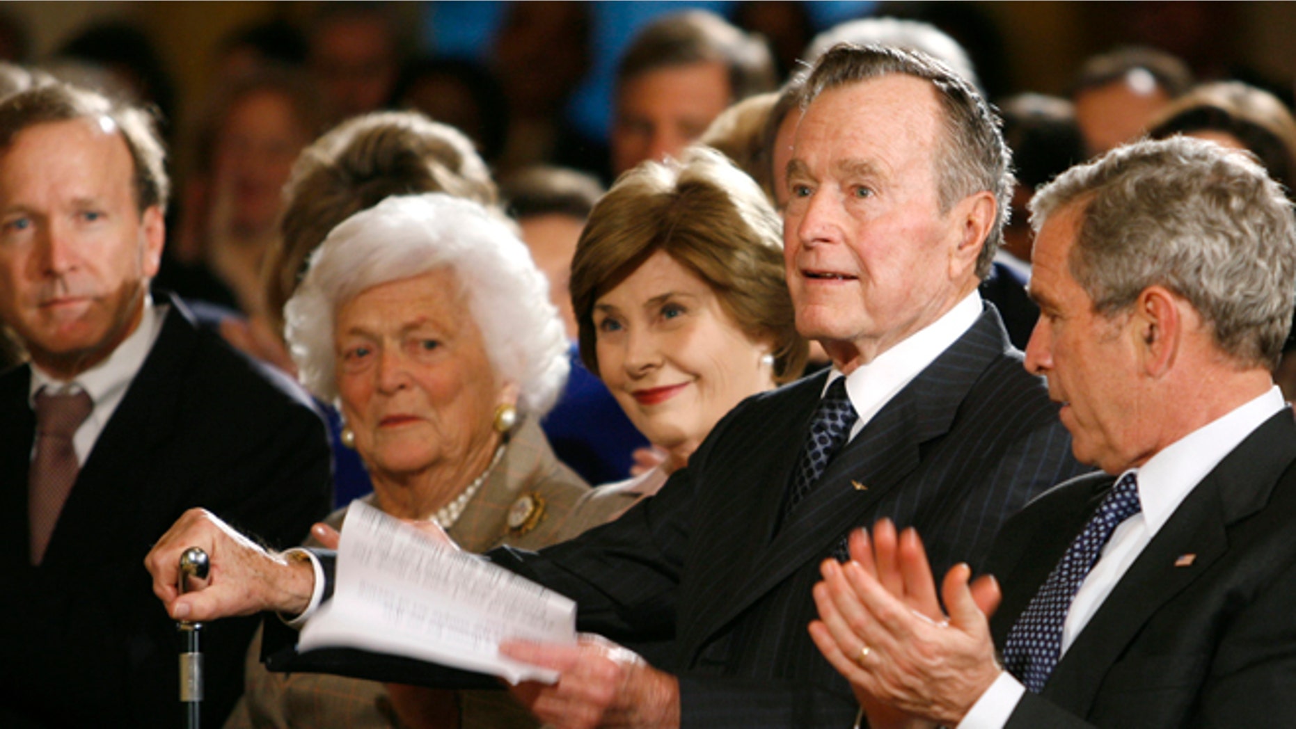 Jan. 7, 2009: Former U.S. President George H.W. Bush rises to speak at a reception in honor of the Points of Light Institute at the White House. Also pictured are Neil Bush, former first lady Barbara Bush, first lady Laura Bush, President George W. Bush.