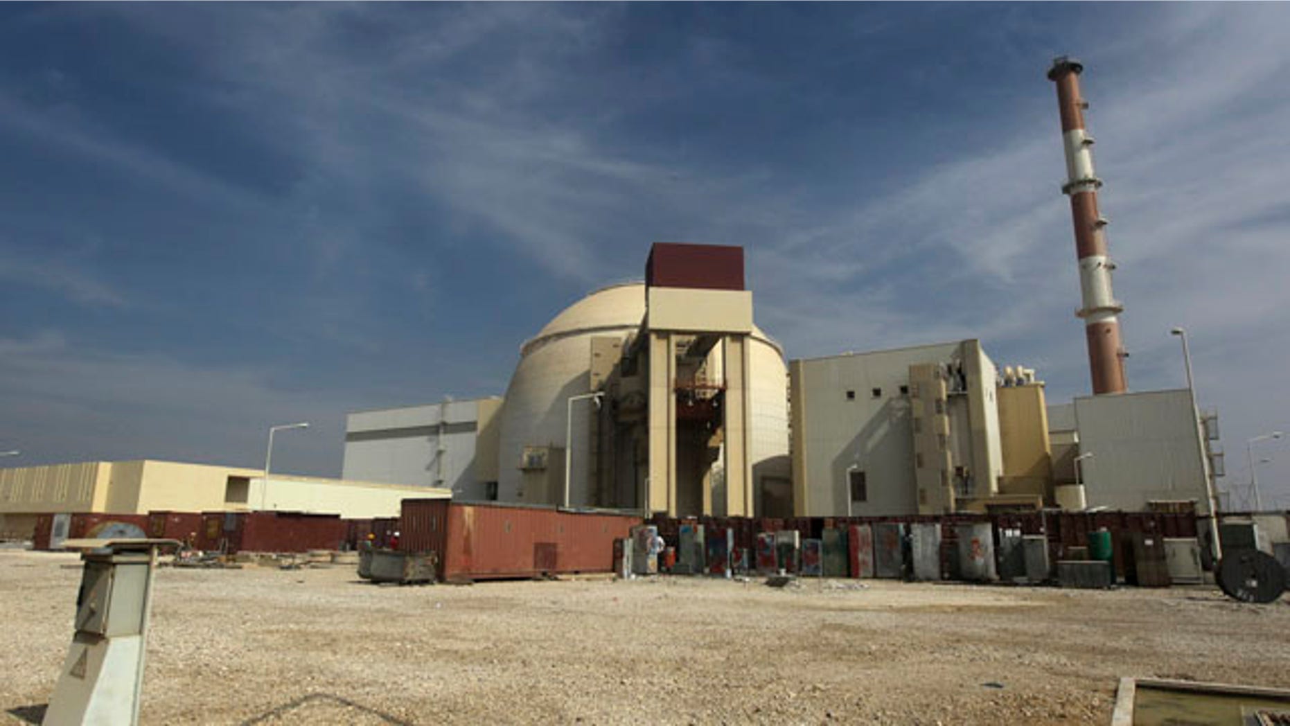 Oct. 26, 2010: A worker rides a bicycle in front of the reactor building of the Bushehr nuclear power plant in Iran.
