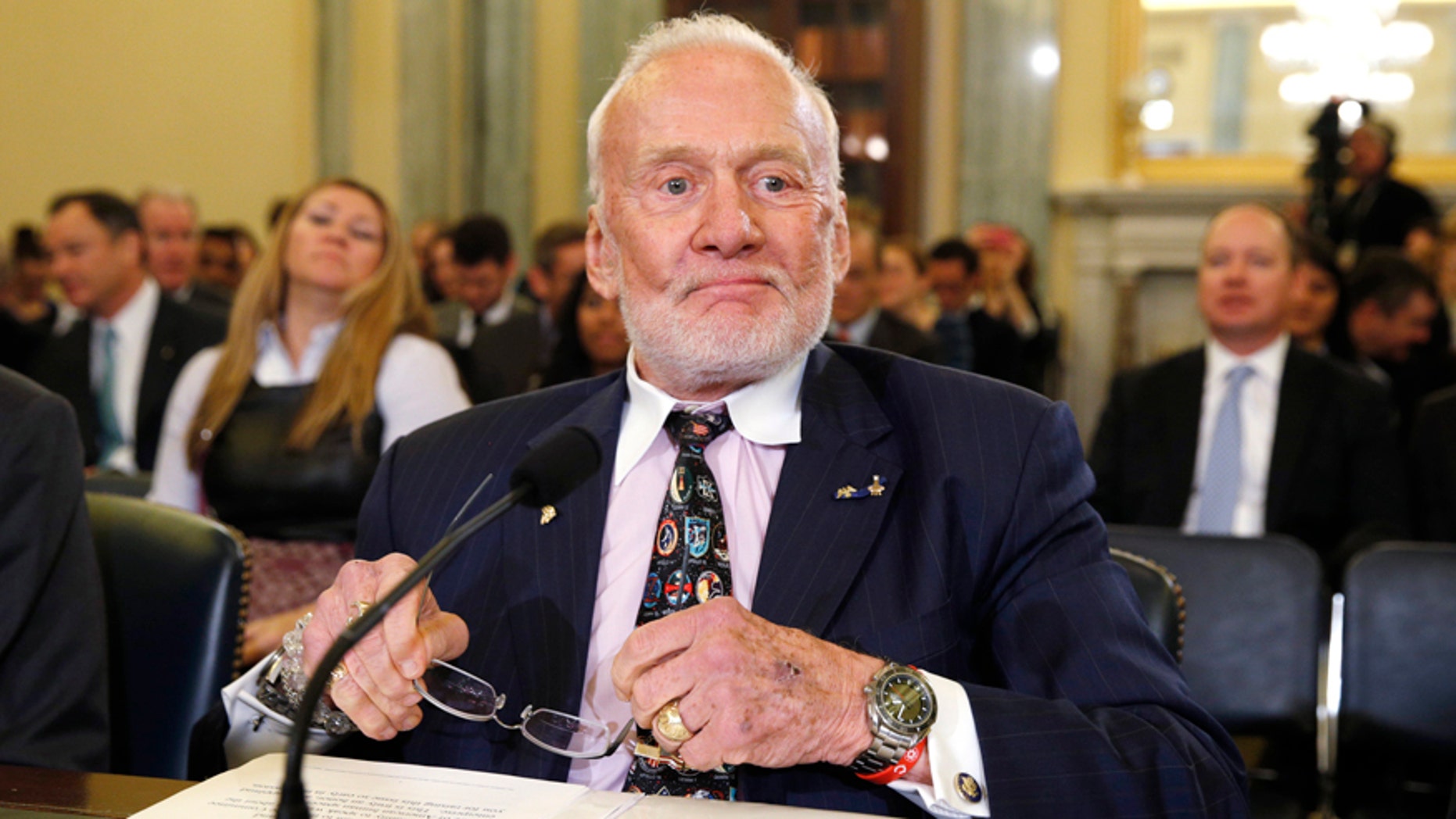 Former astronaut Buzz Aldrin takes his seat to testify before a Senate hearing on Capitol Hill in Washington, February 24, 2015.