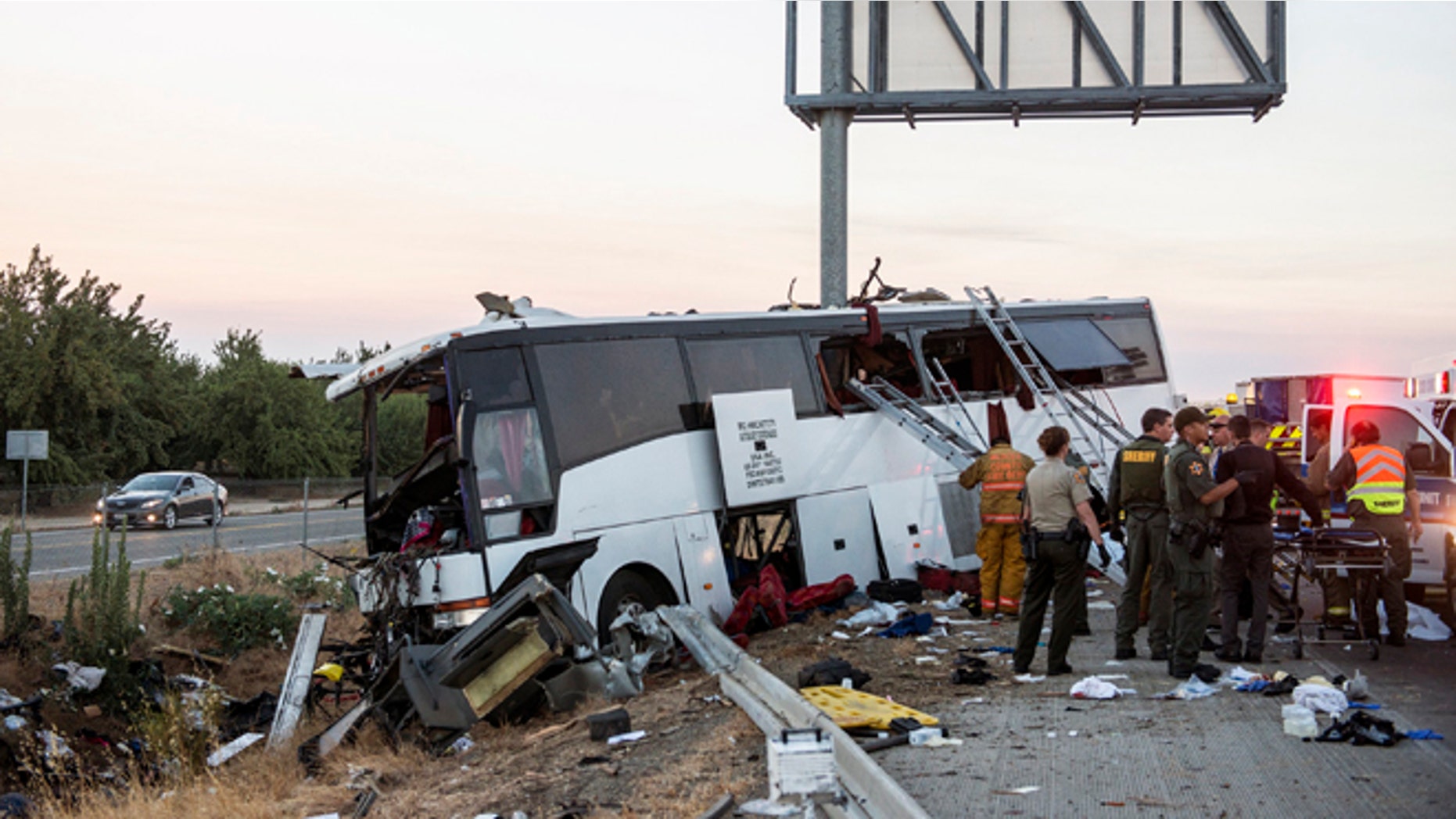 Rescue crews work at the scene of a charter bus crash in Calif., Tuesday, Aug. 2, 2016.