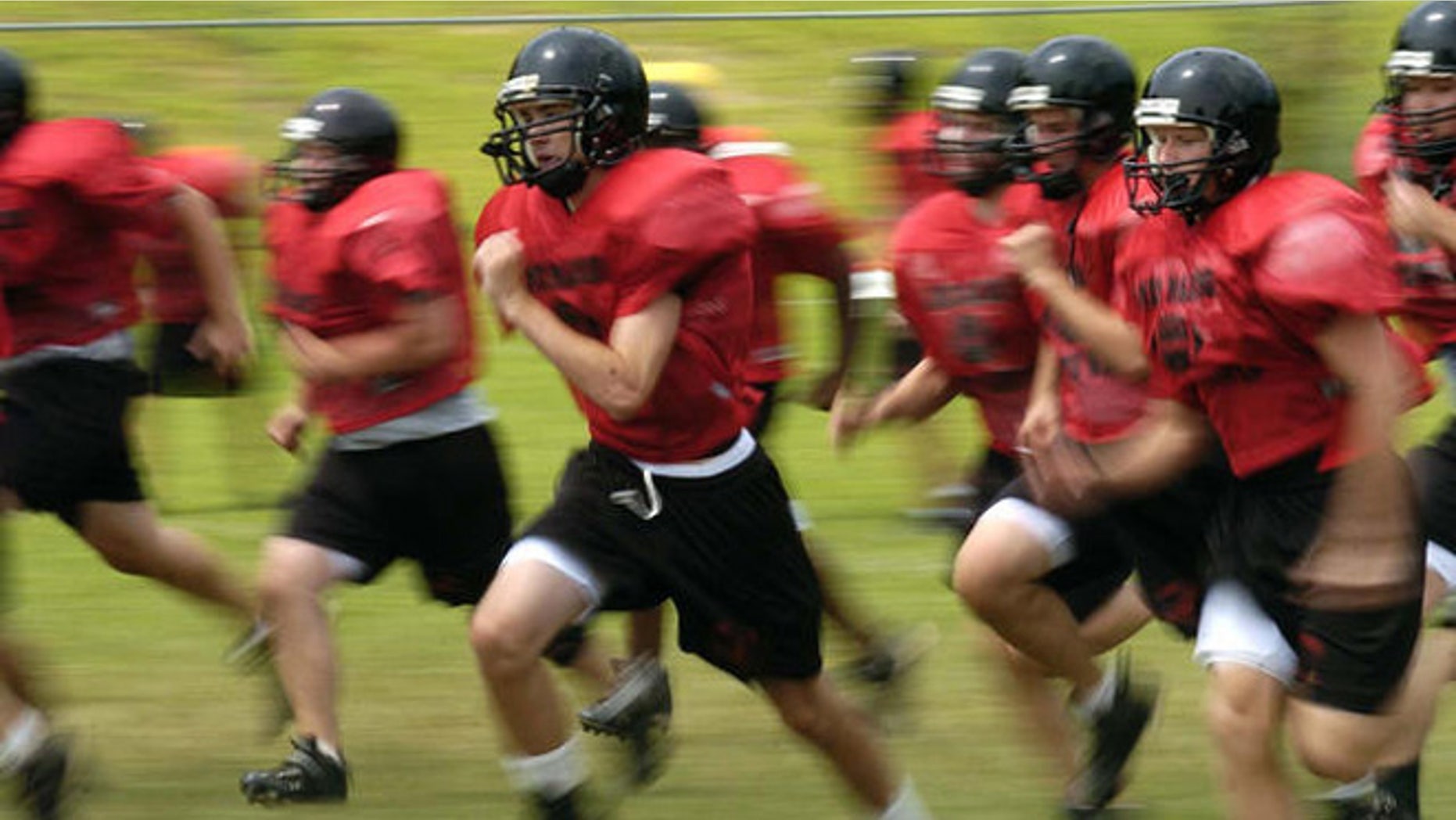 Madison High School football players run sprints during a half pad practice on Friday, Aug. 11, 2006, in Vienna, Va. It's that time of year: Kids hit the ball fields running, and often hobble or are carried off. Back to school means back to organized sports for more than 30 million children and teenagers, and roughly 2.6 million emergency-room visits during the year for resulting injuries. Basketball, football and soccer lead the list of injury-prone team sports. (AP Photo/Kevin Wolf)