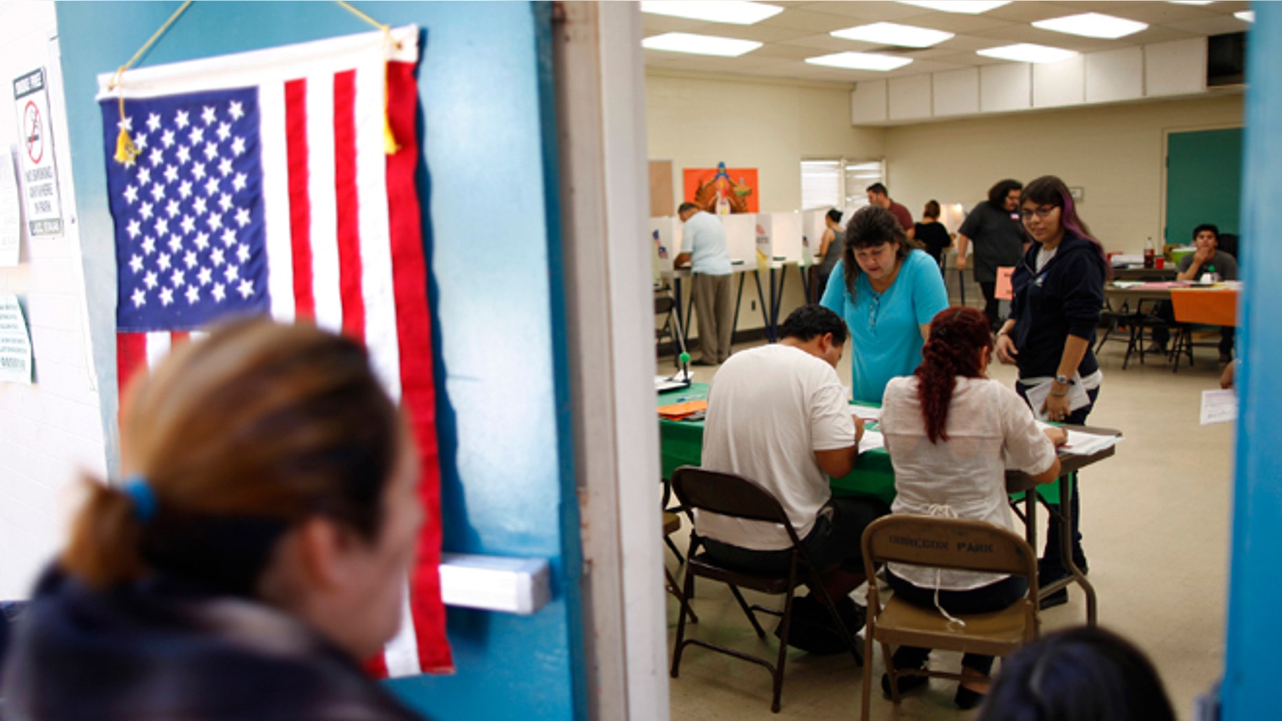 People vote at a polling place in the heavily Latino East L.A. area during the U.S. presidential election on November 6, 2012 in Los Angeles, California. (Photo by David McNew/Getty Images)