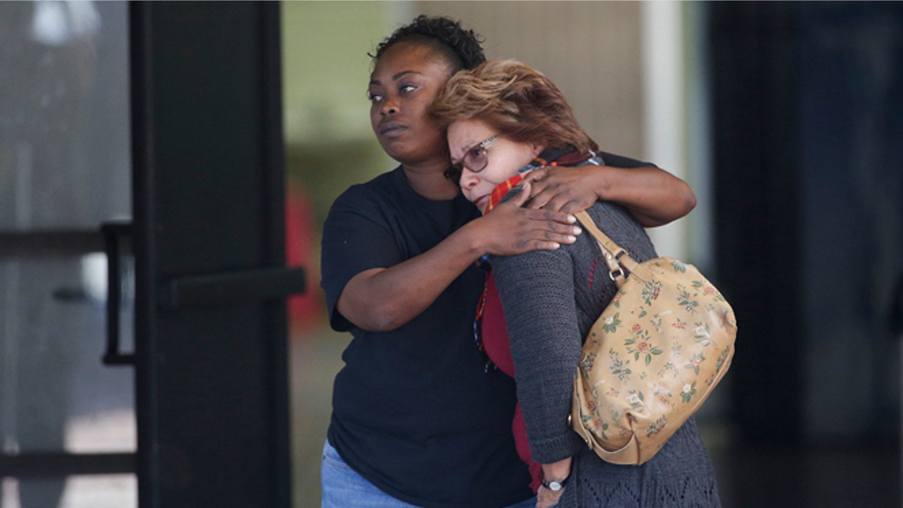 Two women embrace at a community center where family members are gathering to pick up survivors after a shooting rampage that killed multiple people and wounded others at a social services center in San Bernardino, Calif., Wednesday, Dec. 2, 2015. (AP Photo/Jae C. Hong)