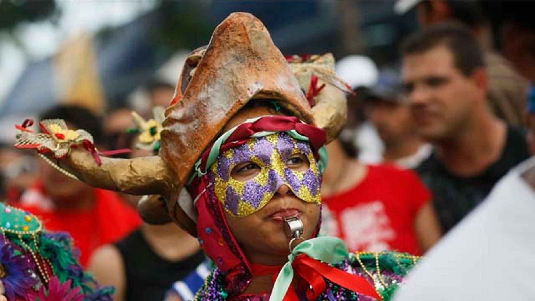 March 16, 2008: Revelers enjoy themselves as they walk along the street during the annual Calle Ocho celebration in the Little Havana neighborhood of Miami, Fla. The event is billed as the largest Hispanic festival in the nation.