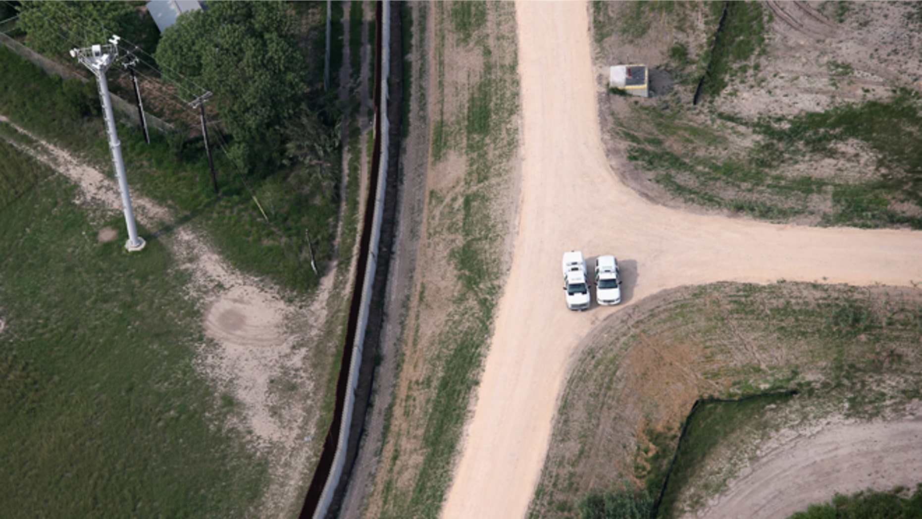 HARLINGEN, TX - MAY 21: Border Patrol officers meet near a border fence and security camera tower near the U.S.-Mexico border on May 21, 2013 near Harlingen, Texas. The area, popular with tourists as well as wildlife, is also attractive to drug smugglers bringing their product north from Mexico into the United States. (Photo by John Moore/Getty Images)