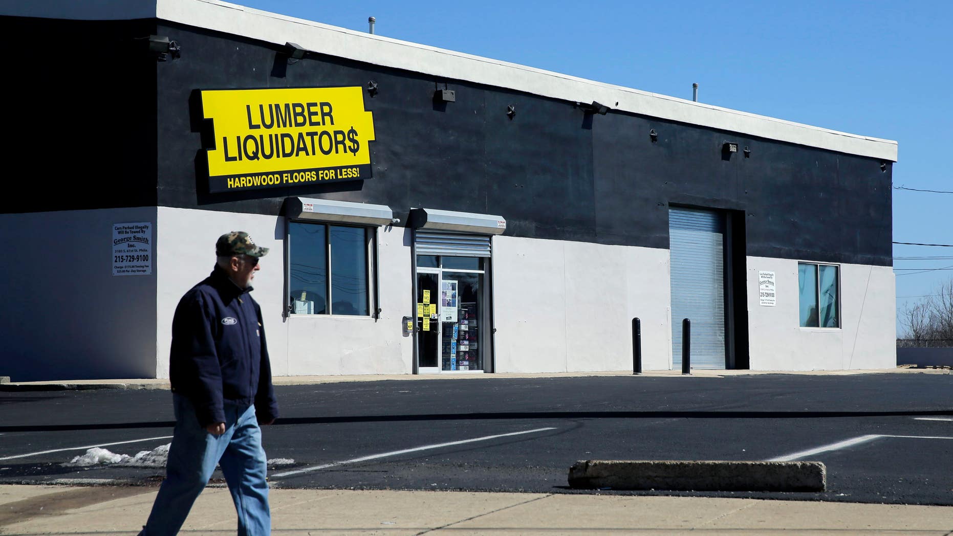In this March 12, 2015, file photo, a man walks past a Lumber Liquidators store in Philadelphia.