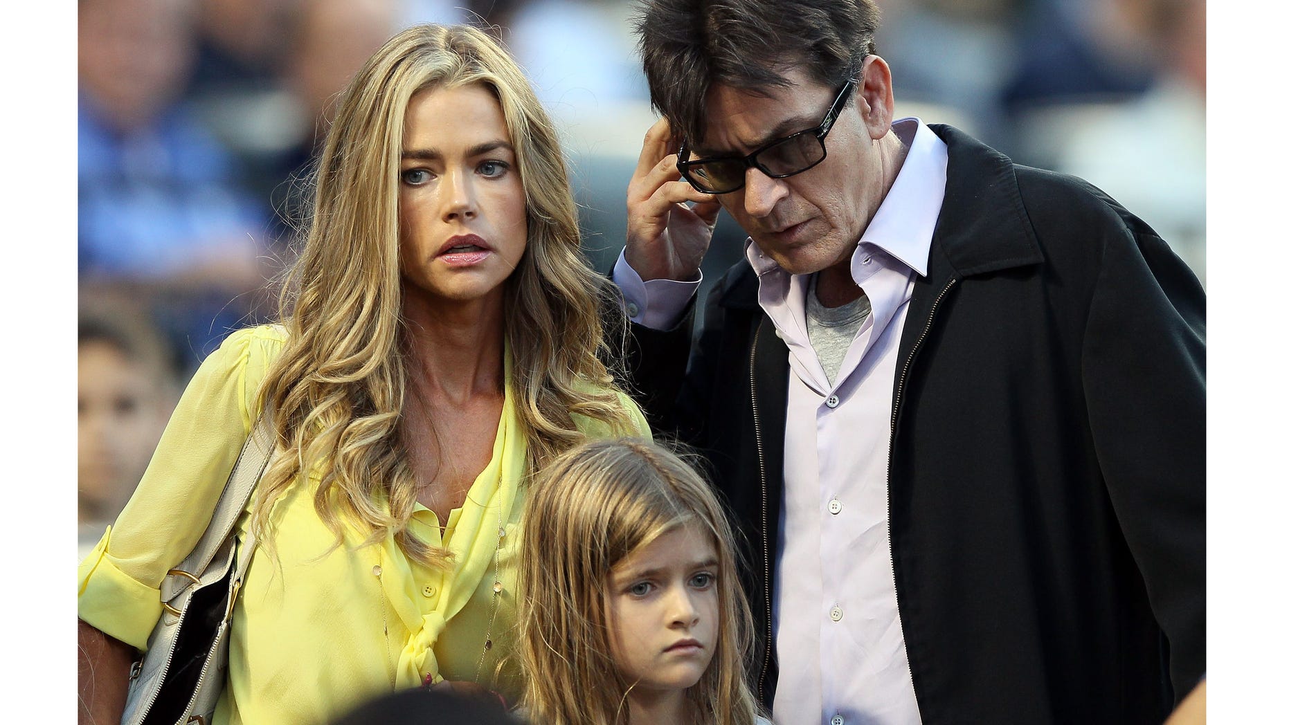 NEW YORK, NY - JUNE 23: Denise Richards and Charlie Sheen look for their seats as the New York Yankees take on the New York Mets on June 23, 2012 during interleague play at Citi Field in the Flushing neighborhood of the Queens borough of New York City. (Photo by Elsa/Getty Images)