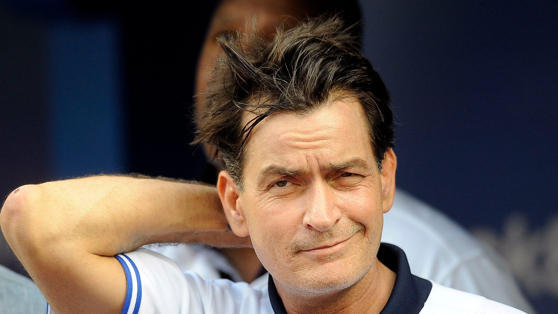 TORONTO, CANADA - AUGUST 14: Actor Charlie Sheen throws out the ceremonial first pitch prior to MLB game action between the Toronto Blue Jays and Chicago White Sox August 14, 2012 at Rogers Centre in Toronto, Ontario, Canada. (Photo by Brad White/Getty Images)