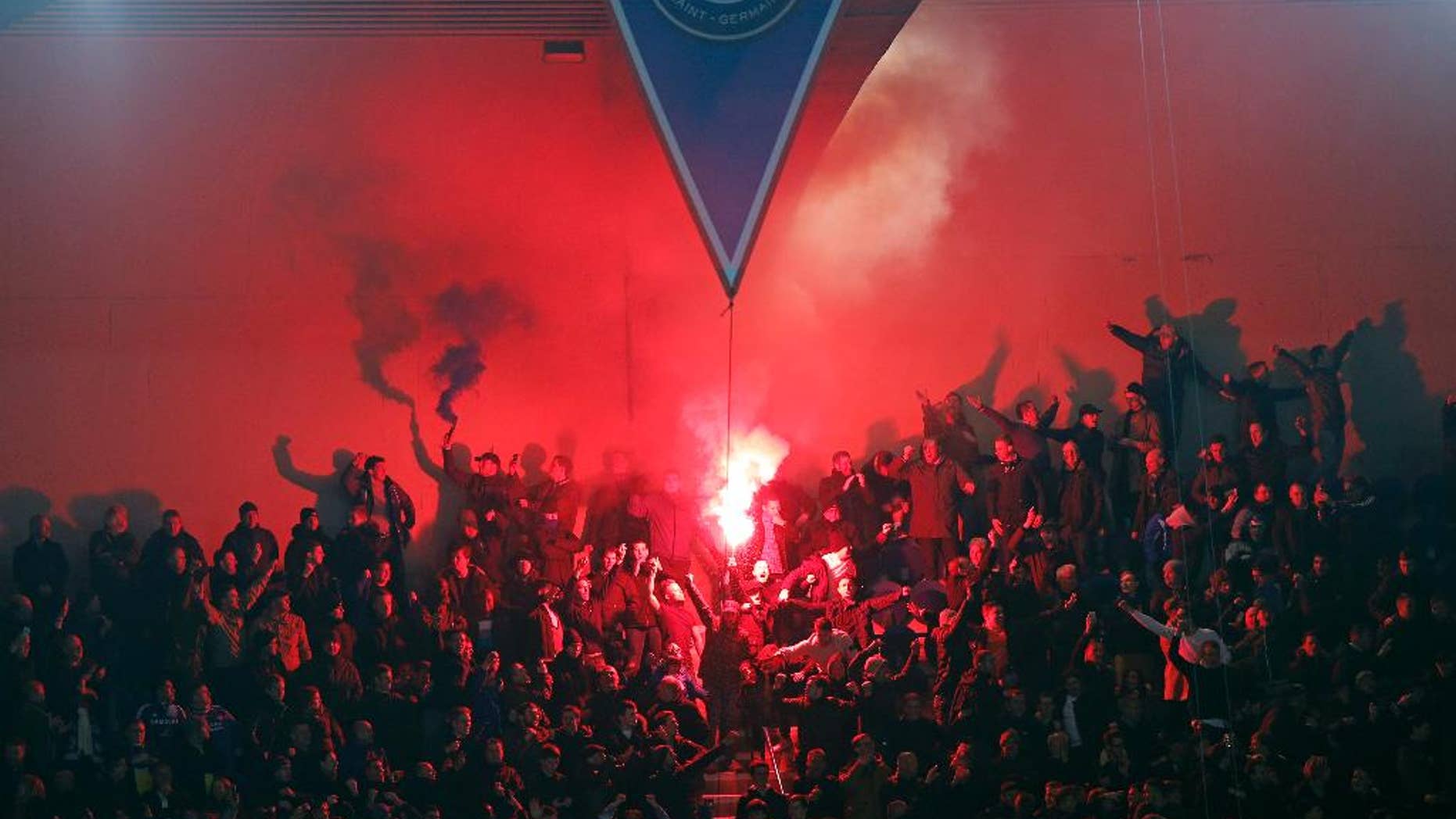 Hinchas de PSG encienden bengalas durante un partido contra Chelsea por la Liga de Campeones el martes, 17 de febrero de 2015, en París. (AP Photo/Christophe Ena)