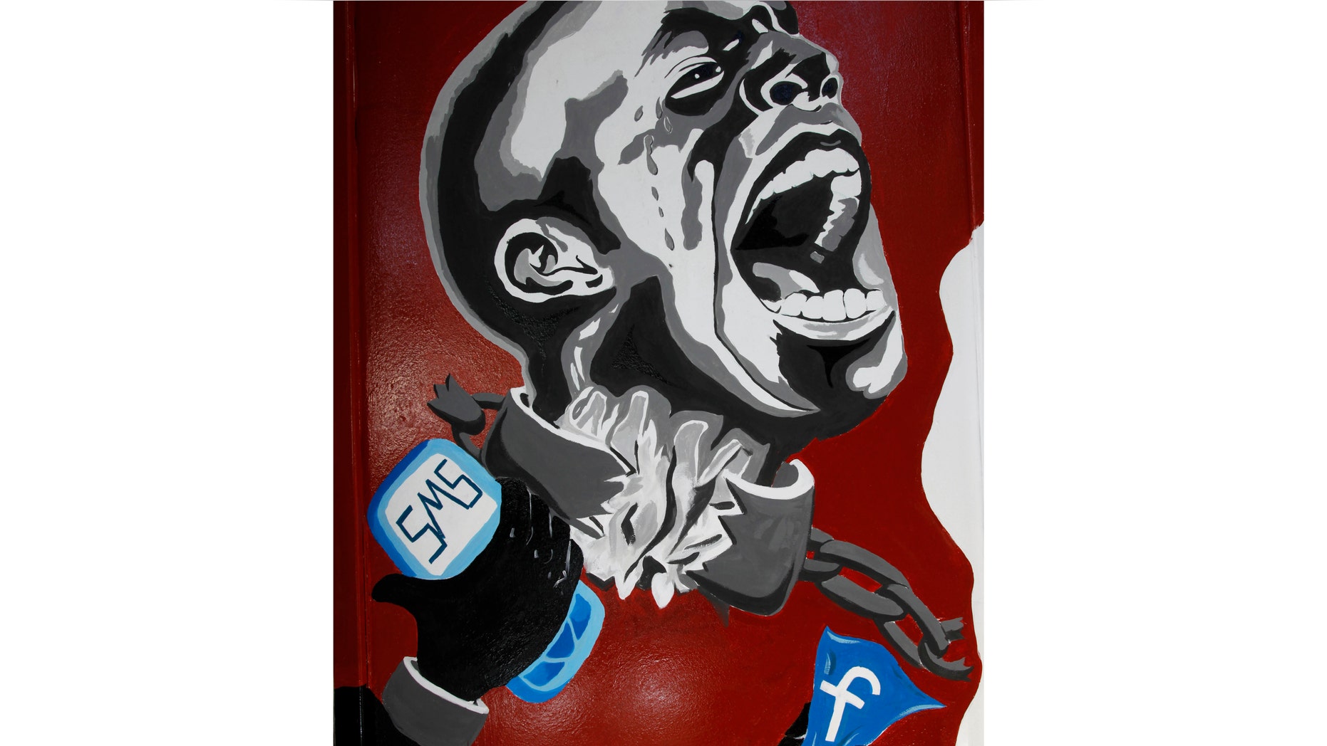 In this March 30, 2011, file photo, a mural depicting a man in shackles and the Facebook logo and a mobile phone is seen in Cairo, Egypt. The CIA center "predicted that social media in places like Egypt could be a game-changer and a threat to the regime"