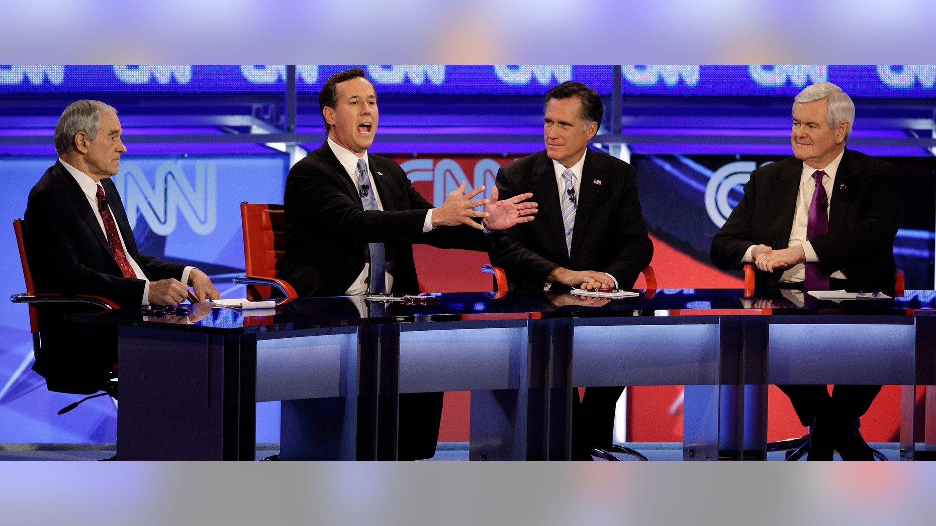 Republican presidential candidates Rep. Ron Paul, R-Texas, left, former Massachusetts Gov. Mitt Romney, second from right, and former House Speaker Newt Gingrich, right, watch as former Pennsylvania Sen. Rick Santorum speaks during a Republican presidential debate Wednesday, Feb. 22, 2012, in Mesa, Ariz. (AP Photo/Jae C. Hong)