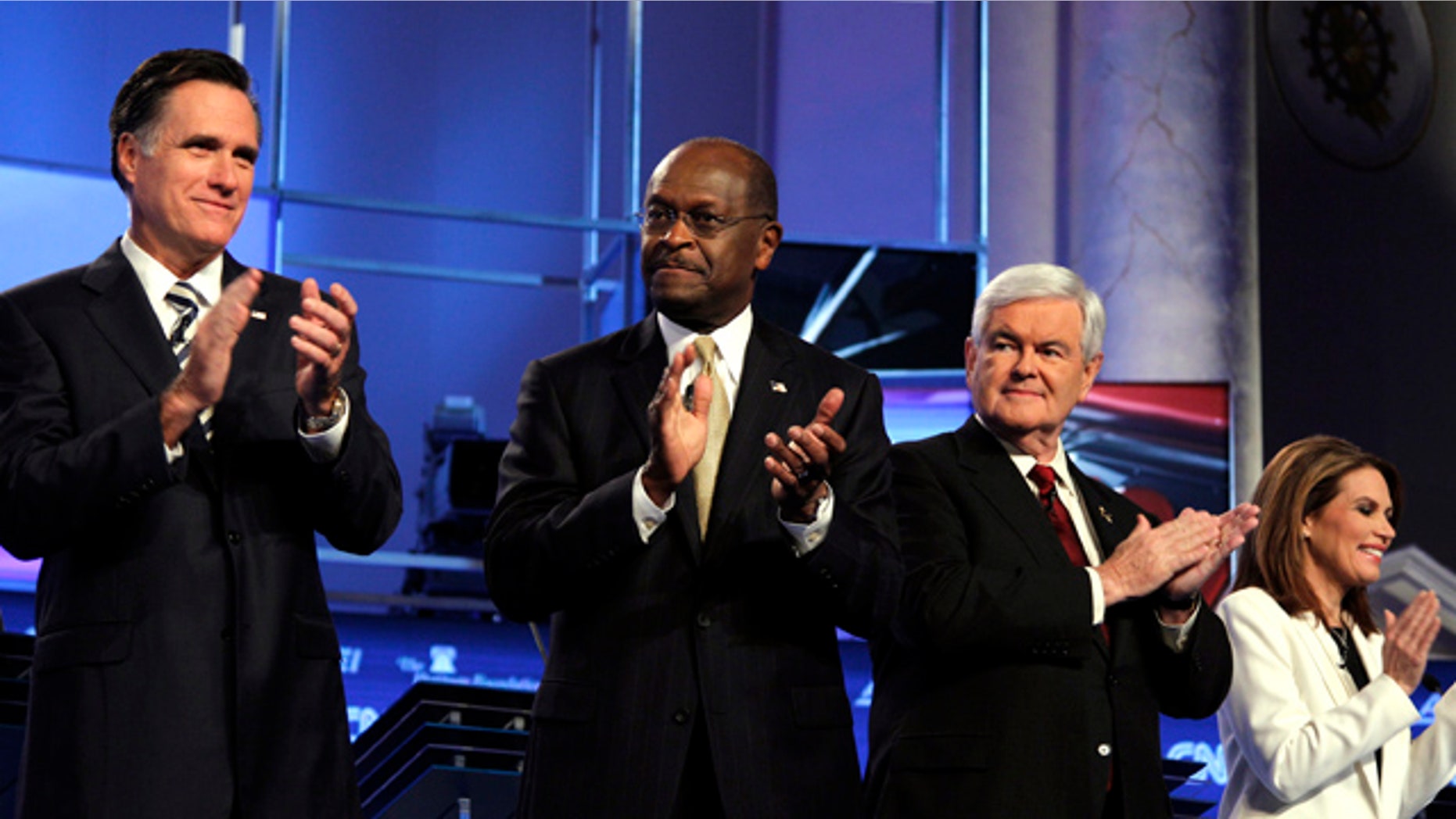 Nov. 22, 2011: Republican presidential candidates from left, former Massachusetts Gov. Mitt Romney, businessman Herman Cain, former House Speaker Newt Gingrich, and Rep. Michele Bachmann, R-Minn., applaud on stage before a Republican presidential debate in Washington.