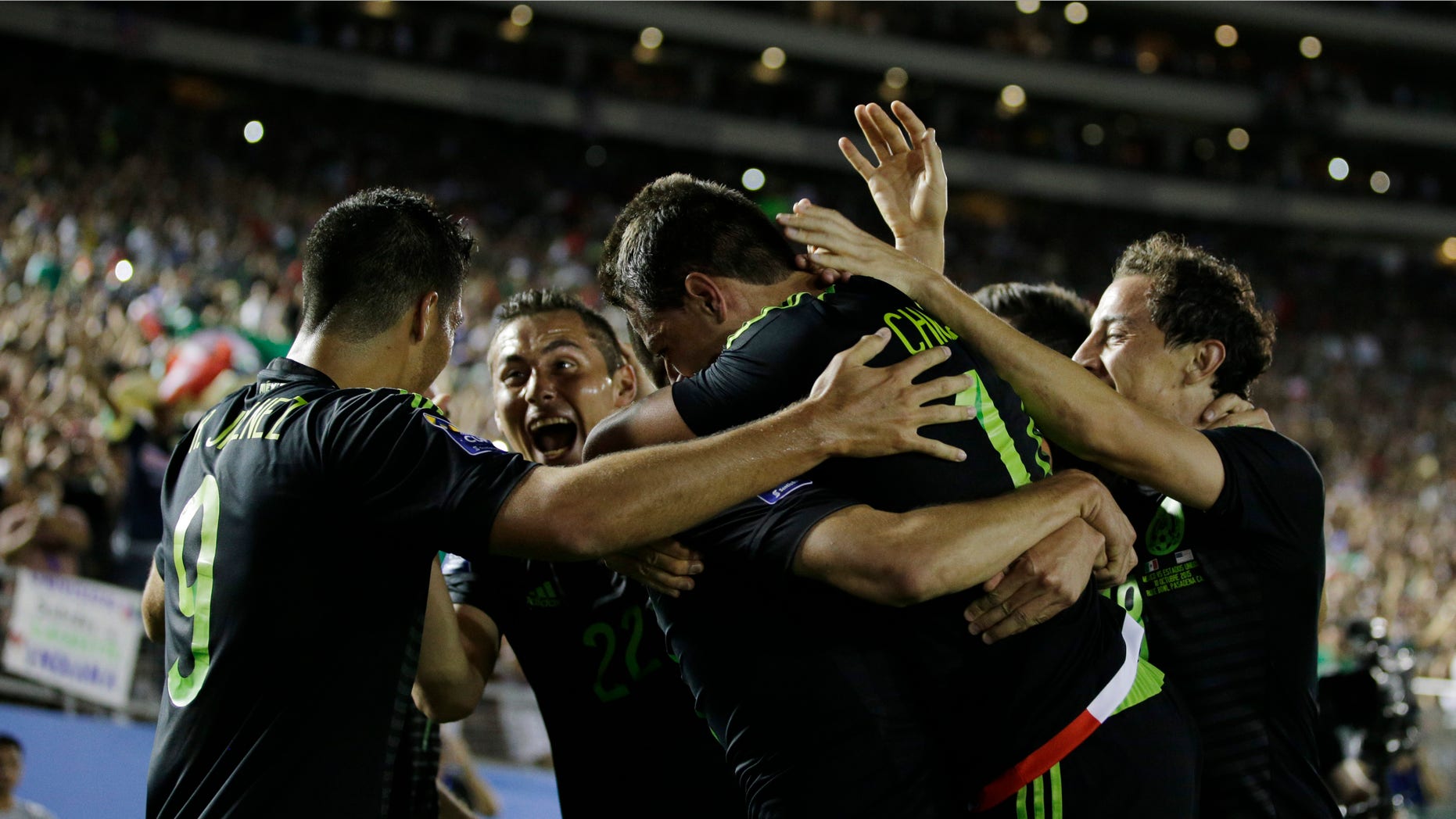 Mexicoâs Javier Hernandez is embraced by teammates after scoring his side's first goal against United States during the CONCACAF Cup soccer match at the Rose Bowl Stadium, in Pasadena , Calif. Saturday, Oct. 10, 2015. (AP Photo/Jae C. Hong)