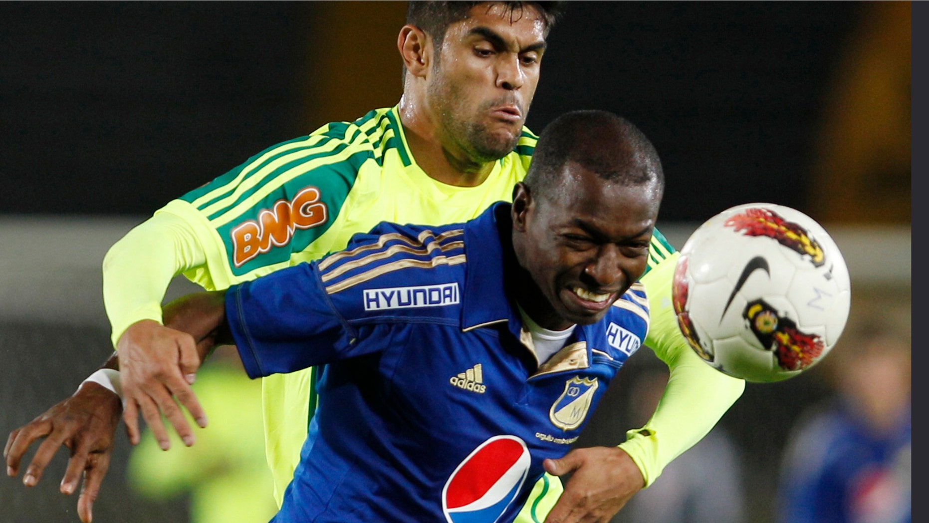 Brazil's Palmeriras' Obina, back, and Colombia's Millonarios' Wason Renteria struggle for the ball during a Copa Sudamericana soccer match in Bogota, Colombia, Tuesday, Oct. 23, 2012. (AP Photo/Fernando Vergara)