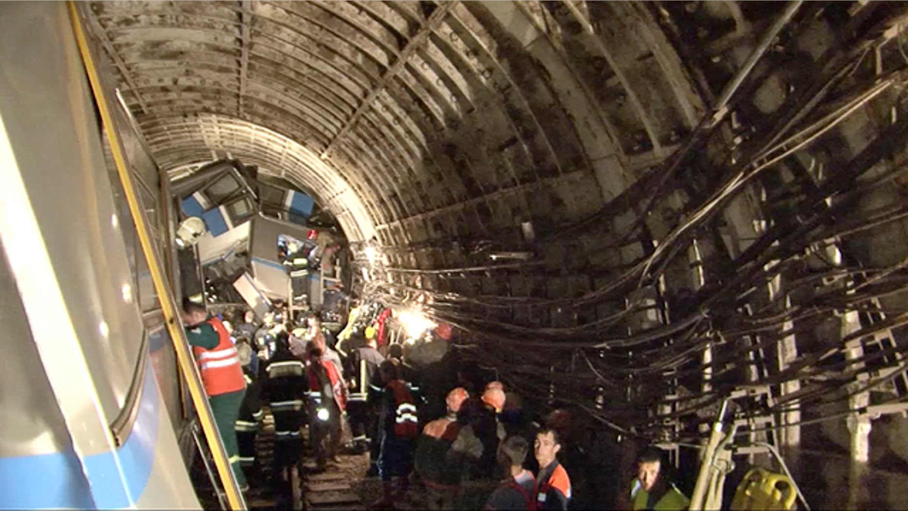 July 15, 2014: This frame grab from a video provided by the Russian Ministry for Emergency Situations shows rescue teams working inside the tunnel where several cars of a wrecked Moscow subway train are located. (AP Photo/Russian Emergency Situation Ministry)