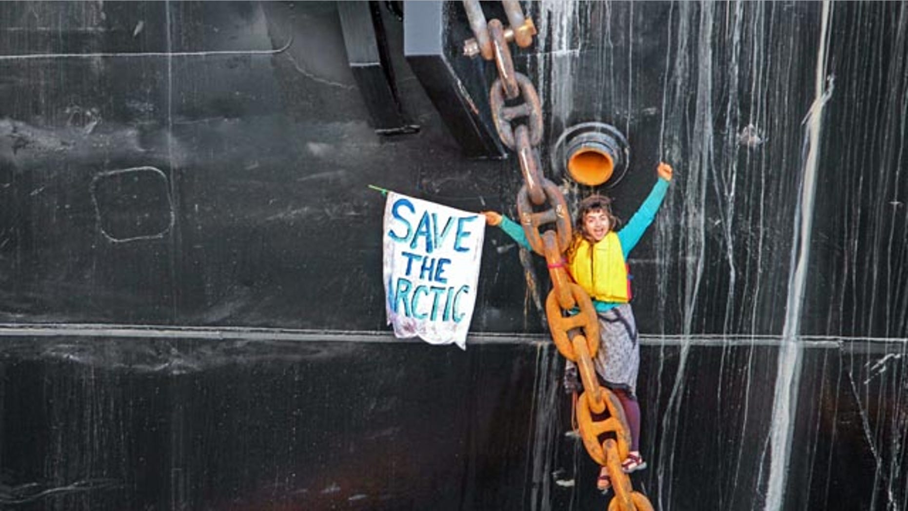 May 22, 2015: A woman identified as Chiara DAngelo hangs in a climbing harness from the anchor chain of the Royal Dutch Shell support ship Arctic Challenger in the harbor at Bellingham, Wash. (Reese Semanko via AP)