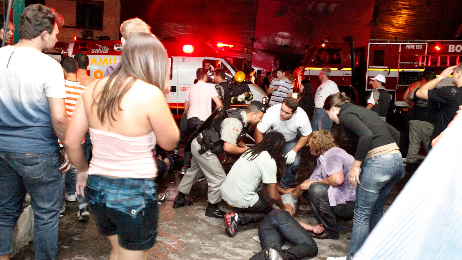 People help an injured man, victim of a nightclub fire, in Santa Maria city, Brazil, on Jan. 27, 2013.
