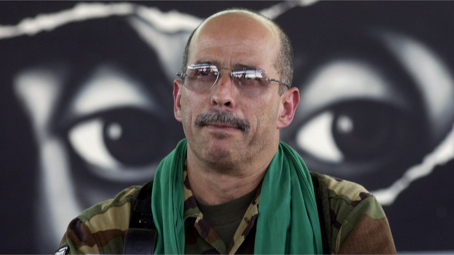 In this Jan. 13, 2002 file photo, Commander of the Revolutionary Armed Forces of Colombia, FARC, Ricardo Palmera, also known as Simon Trinidad, reads a declaration during a press conference in Los Pozos, Colombia. (AP Photo/File)