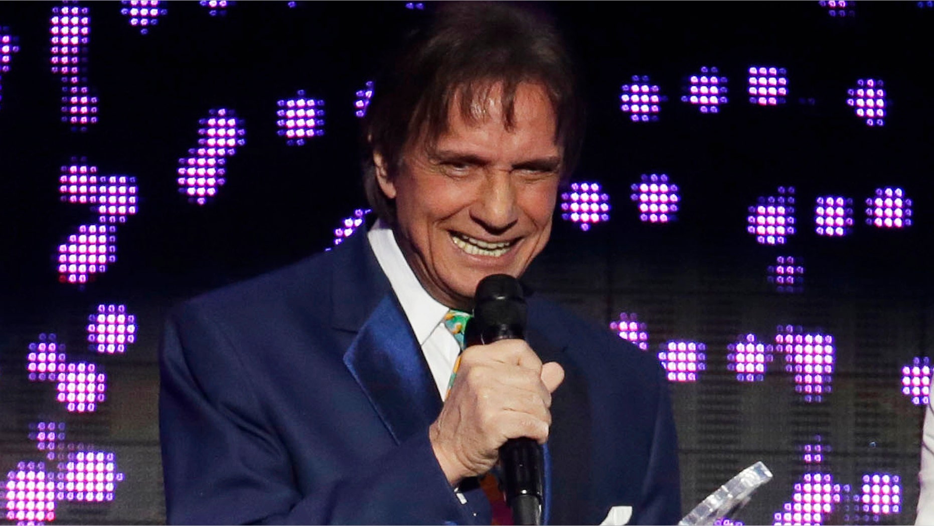 CORRECTS DATE OF EVENT TO NOV 18 - FILE - In this April 30, 2015 file photo, Roberto Carlos receives the Billboard Lifetime Achievement Award at the Latin Billboard Awards in Coral Gables, Fla. Roberto Carlos will be recognized as Person of the Year at a ceremony on Wednesday, Nov. 18, 2015 in Las Vegas, on the eve of the Latin Grammys. (AP Photo/Lynne Sladky, File)