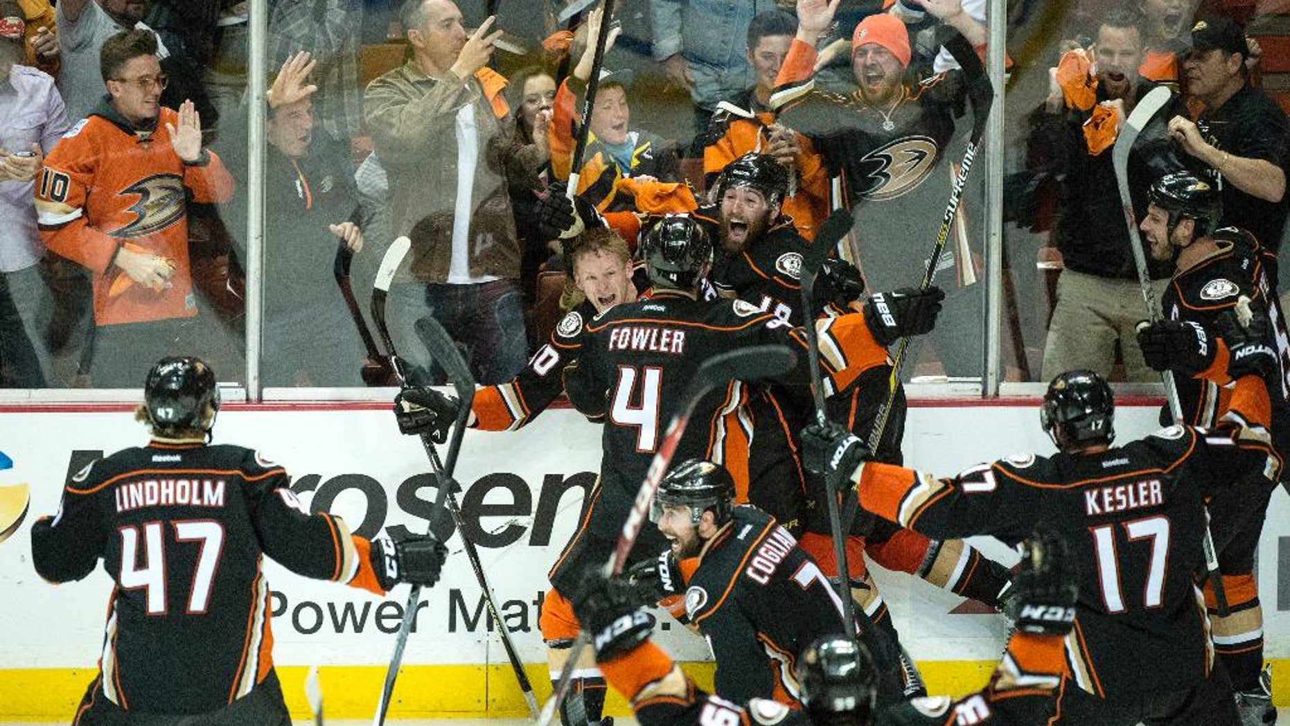 corrects name of the photographerAnaheim Ducks' Corey Perry (10), rear left, celebrates his game-winning goal for a 3-2 overtime win against Calgary in Game 5 of a second-round series in the NHL hockey playoffs in Anaheim, Calif., Sunday, May 10, 2015. Anaheim eliminated Calgary and will face the Chicago Blackhawks in the Western Conference finals. (Kyusung Gong/The Orange County Register via AP) LA TIMES OUT MAGS