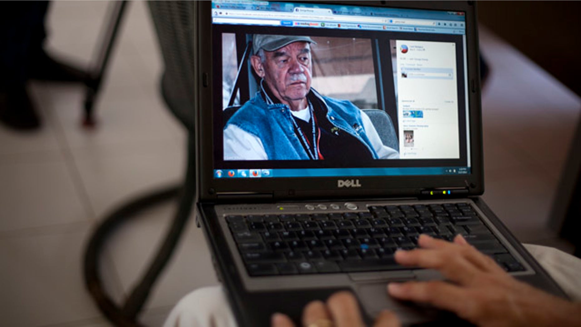 May 17, 2014: A picture of George Knoop, 77, an American missionary who was killed at his home this week, is displayed in a laptop by a member of the mission in Port-au-Prince, Haiti. (AP Photo/Dieu Nalio Chery)