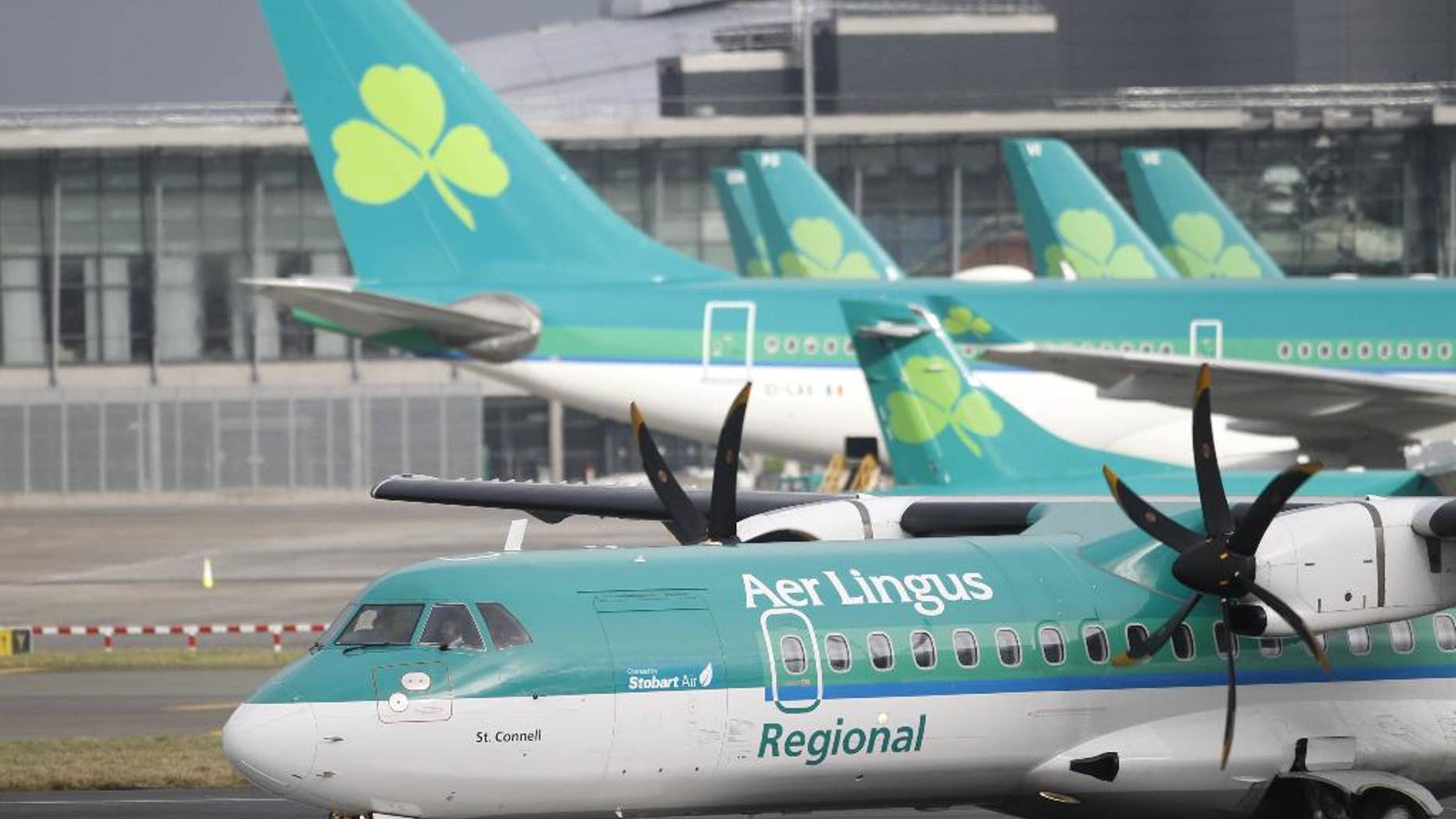 CAPTION CORRECTION, CORRECTS FROM AIG TO IAG IN SECOND SENTENCE - FILE - In this Tuesday, Jan. 27, 2015 file photo, Aer Lingus planes at Dublin airport, Ireland. The Irish government said Tuesday, May 26, 2015 that it intends to sell its 25 percent stake in Aer Lingus to IAG after receiving guarantees that the parent company of British Airways will increase employment and air links with the United States. (AP Photo/Peter Morrison, File)