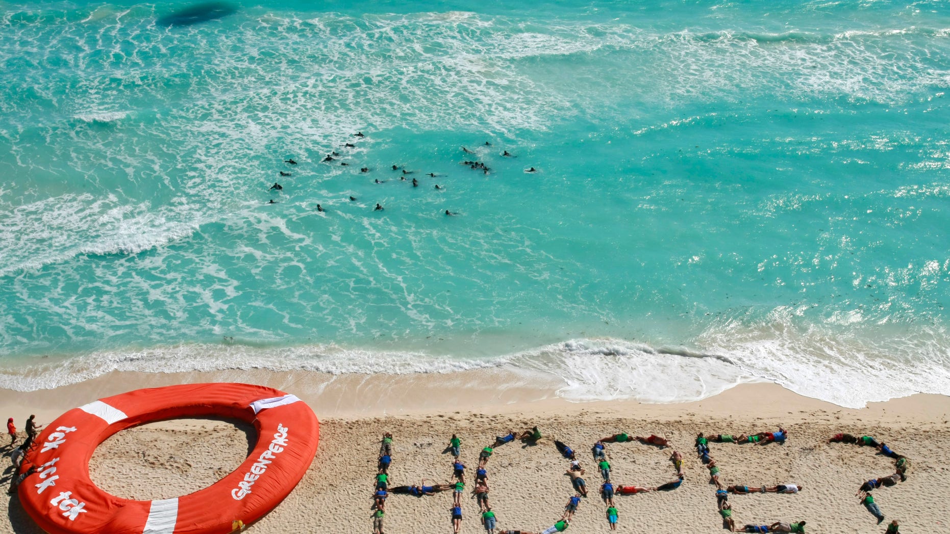 Dec. 10: Greenpeace activists form the word hope as a question with their bodies, next to a giant life saver, during a demonstration near the site of the United Nations Climate Change Conference in Cancun, Mexico.