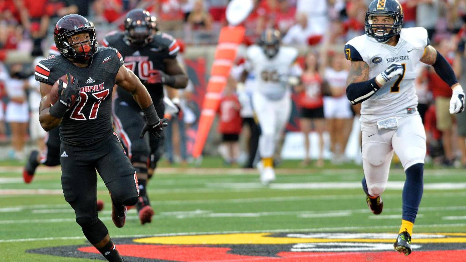 CORRECTS ID TO L.J. SCOTT, NOT GREG WILLARD - Louisville's L.J. Scott, left, outruns the pursuit of Murray State's Anthony Hayes during the second quarter of their NCAA college football game Saturday, Sep. 6, 2014 at Papa John's Cardinal Stadium in Louisville, Ky. (AP Photo/Timothy D. Easley)