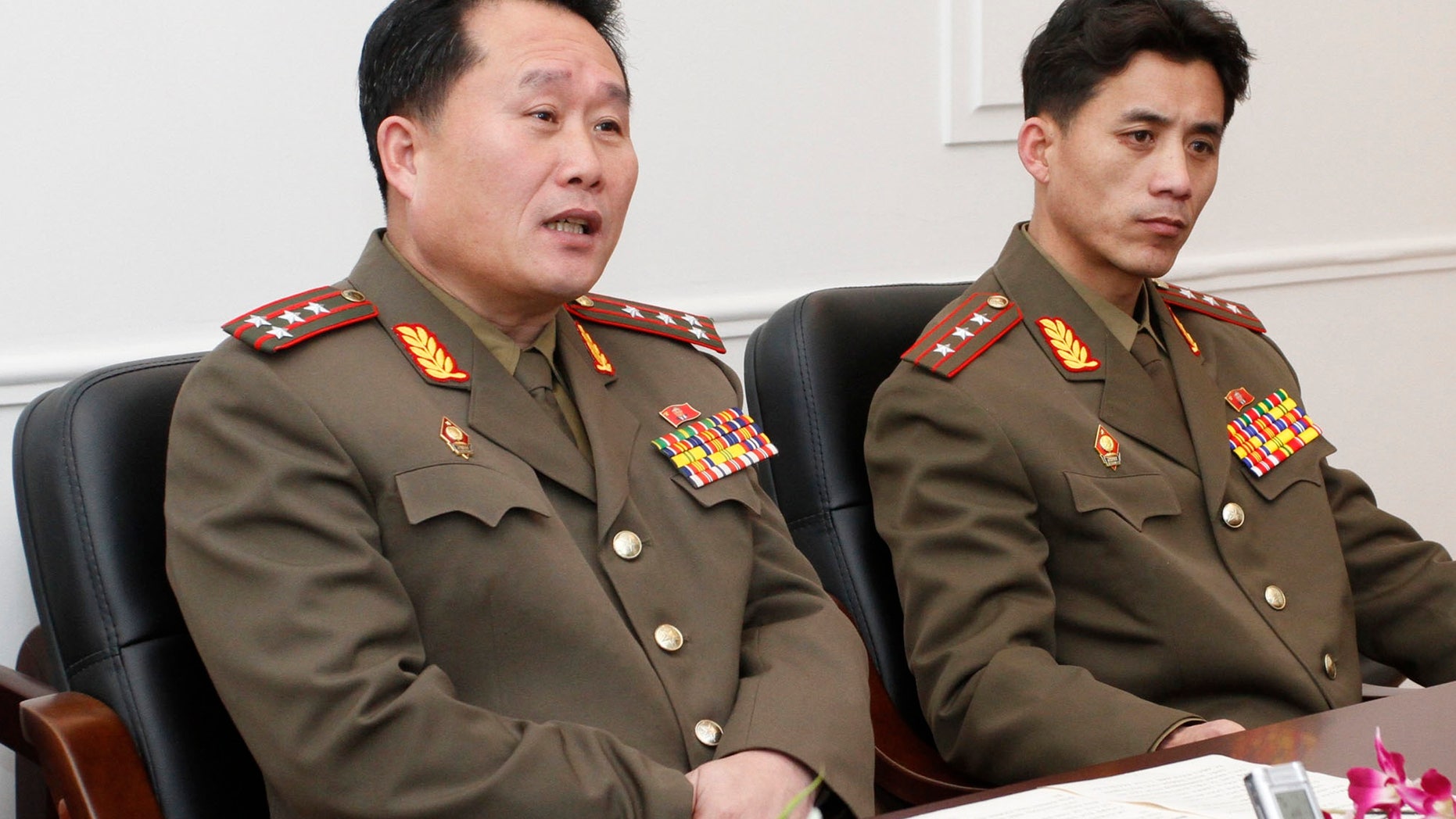Feb. 2, 2012: Ri Son Gwon, left, a colonel working for the Policy Department of North Korea’s National Defense Commission, accompanied by an unidentified official speaks in Pyongyang.