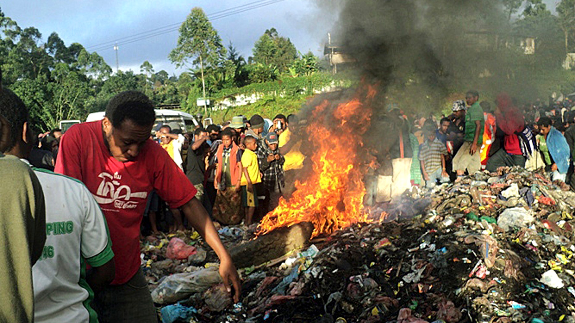 Feb. 6, 2013 - FILE photo: Hundreds of bystanders watch Kepari Leniata, a woman accused of witchcraft, being burned alive in the Western Highlands provincial capital of Mount Hagen in Papua New Guinea. There is no clear explanation for the apparent uptick in killings in parts of the South Pacific nation, and even government officials seem at a loss to say why this is happening. Some argue recent violence is fueled not by the nation's widespread belief in black magic but instead by economic jealousy.