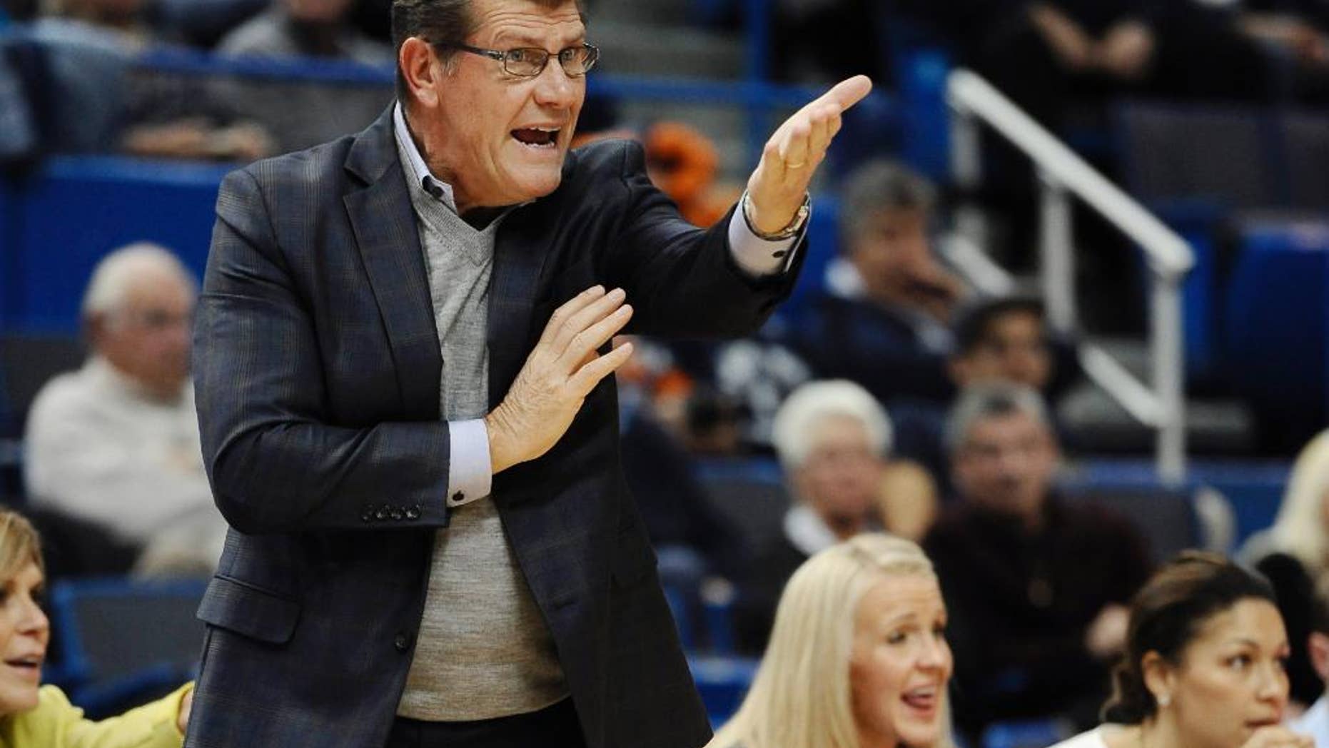 THIS CORRECTS THE NAME OF THE SCHOOL TO POST, NOT C.W. POST AS ORIGINALLY SAENT - Connecticut Geno Auriemma gestures to his team during the first half of an NCAA college basketball game against Post, Sunday, Nov. 9, 2014, in Hartford, Conn. (AP Photo/Jessica Hill)