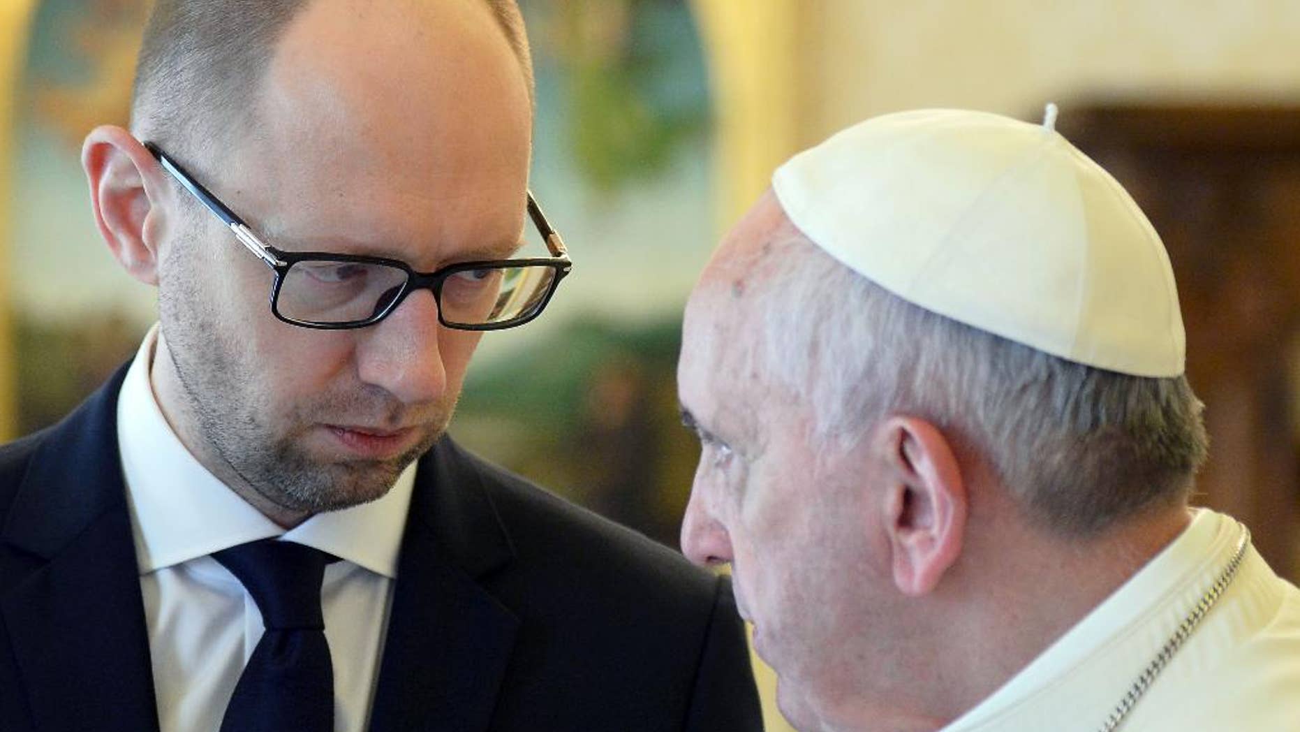 CORRECTS OBJECT NAME. Pope Francis and Ukrainian Prime Minister Arseny Yatsenyuk look at each other on the occasion of their private audience at the Vatican, Saturday, April 26, 2014. Yatsenyuk is in Rome to attend Sunday's canonization ceremony for John Paul II and John XXIII where Pope Francis will elevate the two popes to sainthood. (AP Photo/Vincenzo Pinto, Pool)