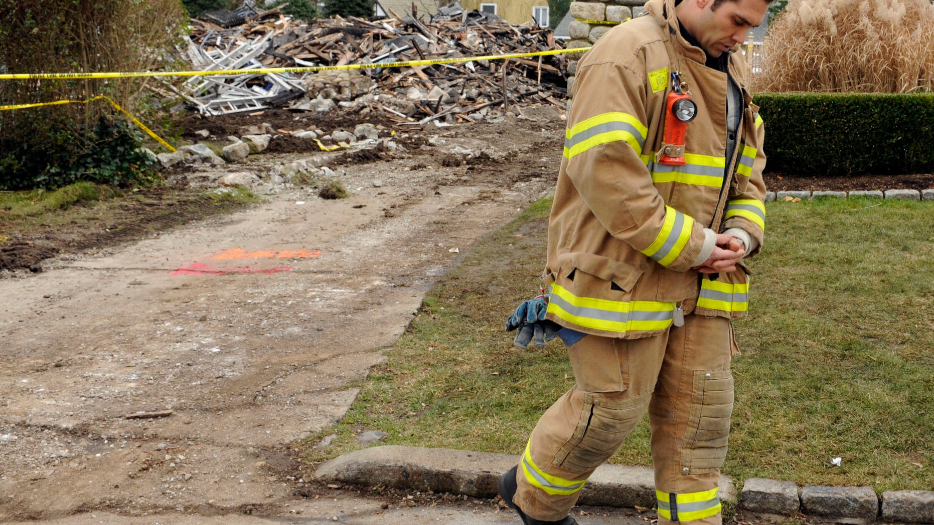 December 27: Stamford firefighter Nick Tamburro pays respect outside the home of Madonna Badger in Stamford, Connecticut. A fire at the home on Christmas morning killed Badger’s three daughters and parents.
