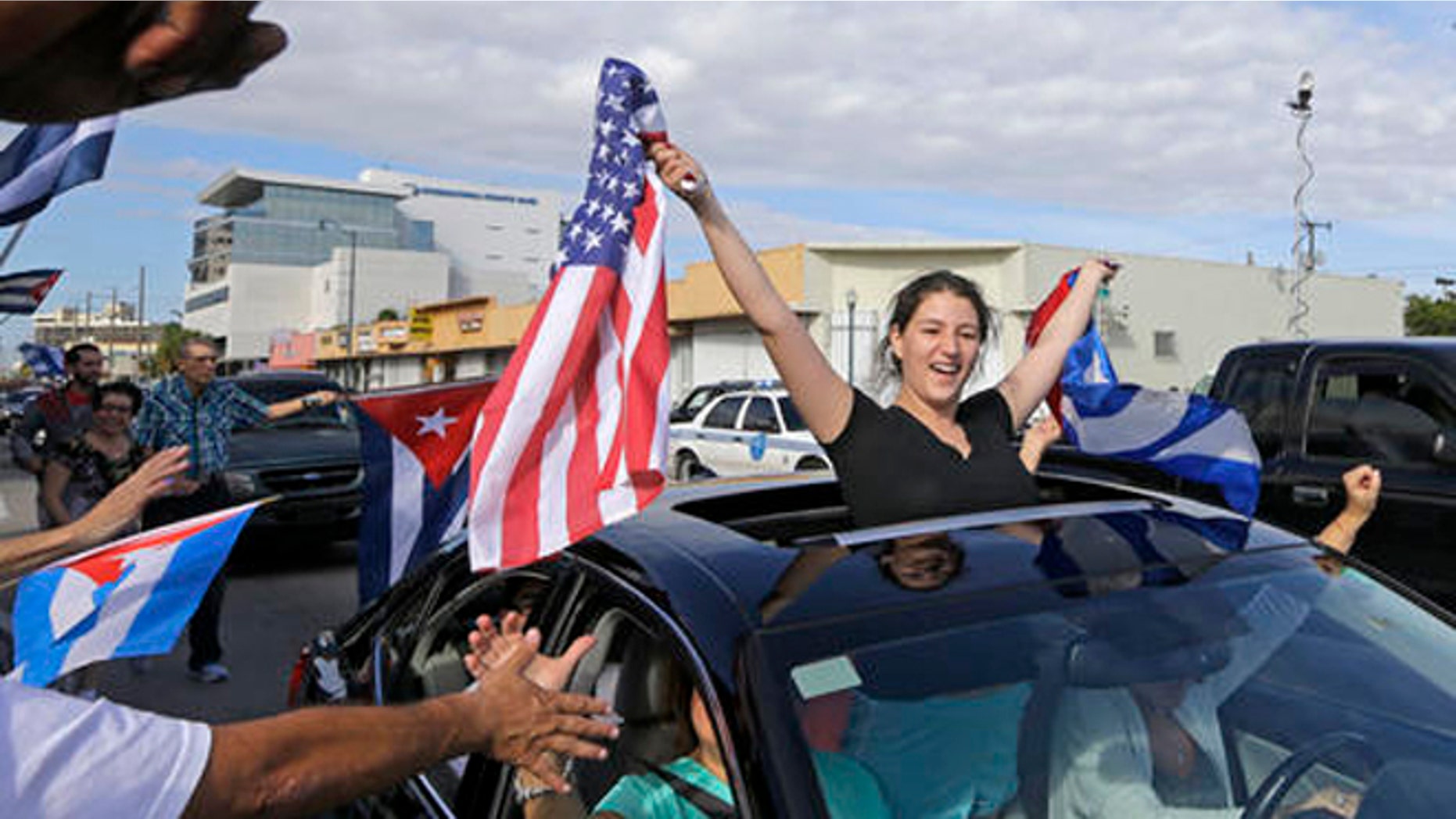 File- In this Nov. 26, 2016, file photo, Cuban-Americans react to the death of Fidel Castro, Saturday, Nov. 26, 2016, in the Little Havana area in Miami. For the hundreds of thousands of children born of Cuban exiles, some who are two and three generations removed from the island, Fidel Castros death potentially opens a door to a world previously off-limits. (AP Photo/Alan Diaz, File)