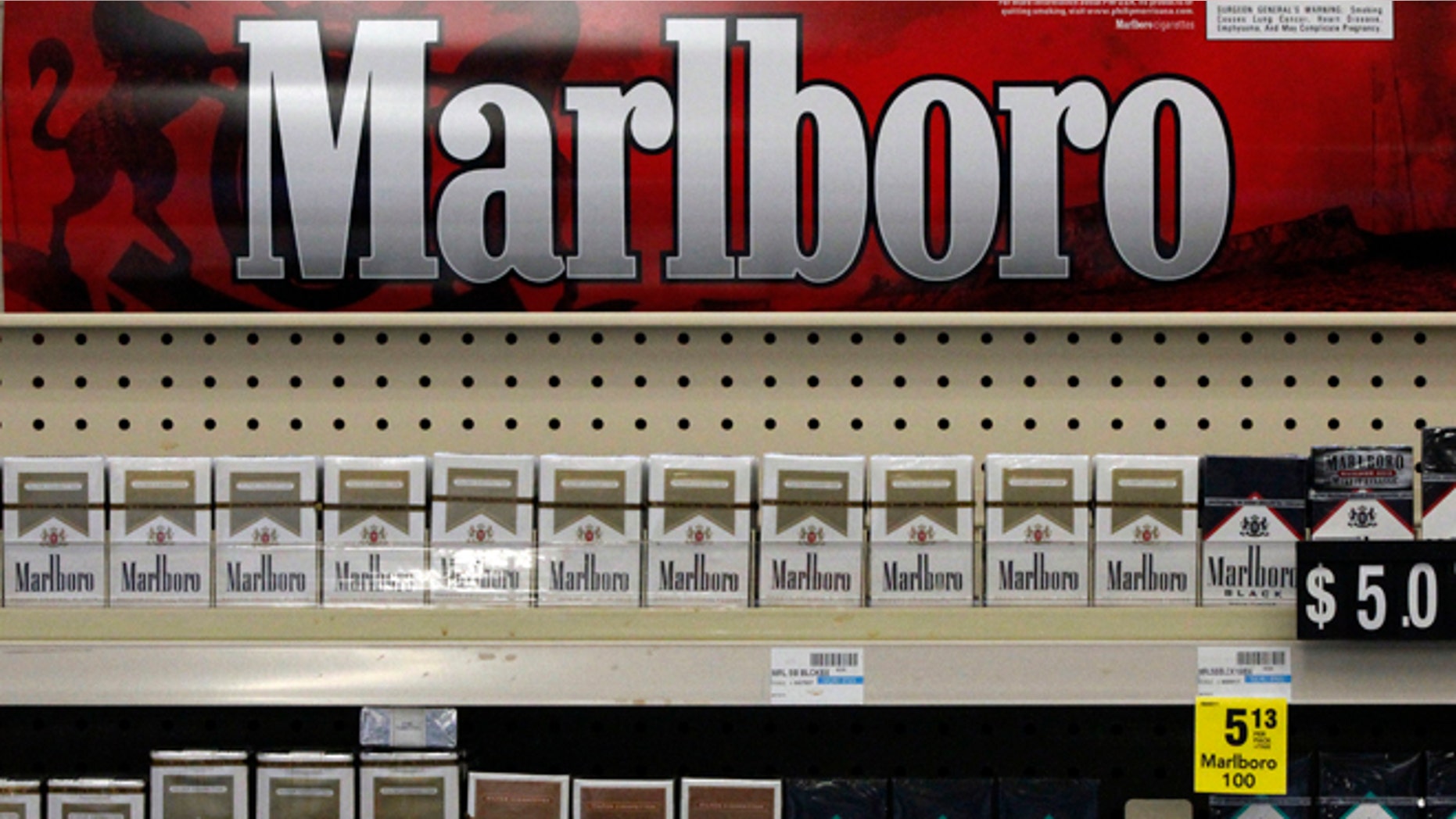 FILE - In this Wednesday, July 17, 2013 file photo, Marlboro cigarettes are on display in a CVS store in Pittsburgh. The nation's second-largest drugstore chain says it will phase out cigarettes, cigars and chewing tobacco by Oct. 1 as it continues to focus more on health care. The move will cost the Woonsocket, R.I., company about $2 billion in annual revenue. (AP Photo/Gene J. Puskar, File)