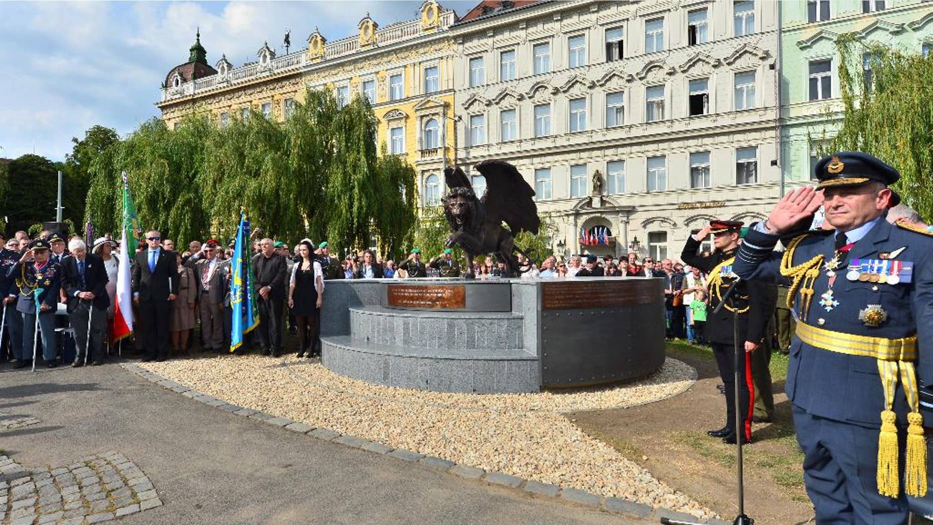 The monument in memory of Czechoslovak WWII pilots in the British Royal Air Force (RAF), which is opposed by heritage protectors, was unveiled in a park in Prague centre, Tuesday, June 17, 2014. The two-metre bronze statue of a winged lion, made by British sculptor Colin Spofforth, stands on a concrete plinth. It was donated by the British community living in the Czech Republic. (AP Photo/CTK, Vit Simanek) SLOVAKIA OUT