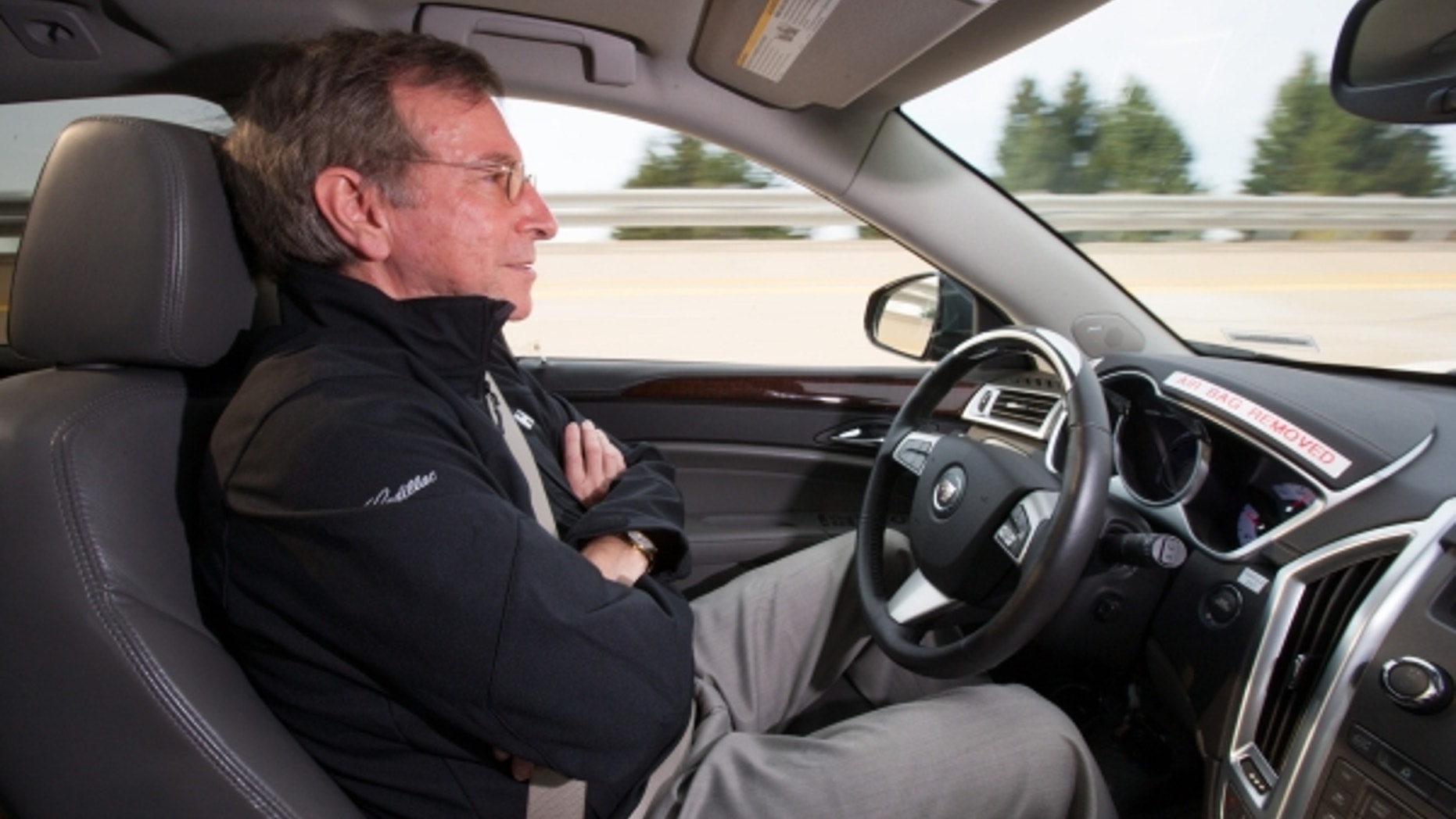 General Motors Staff Researcher Dr. Jeremy Salinger road tests a Cadillac semi-autonomous driving technology it calls “Super Cruise” that is capable of fully automatic steering, braking and lane-centering in highway driving under certain optimal conditions Friday, March 23, 2012 in Milford, Michigan. Super Cruise is designed to ease the driver’s workload on the freeway, in both bumper-to-bumper traffic and on long road trips by relying on a fusion of radar, ultrasonic sensors, cameras and GPS map data. The system could be ready for production vehicles by mid-decade. (Photo by John F. Martin for Cadillac)