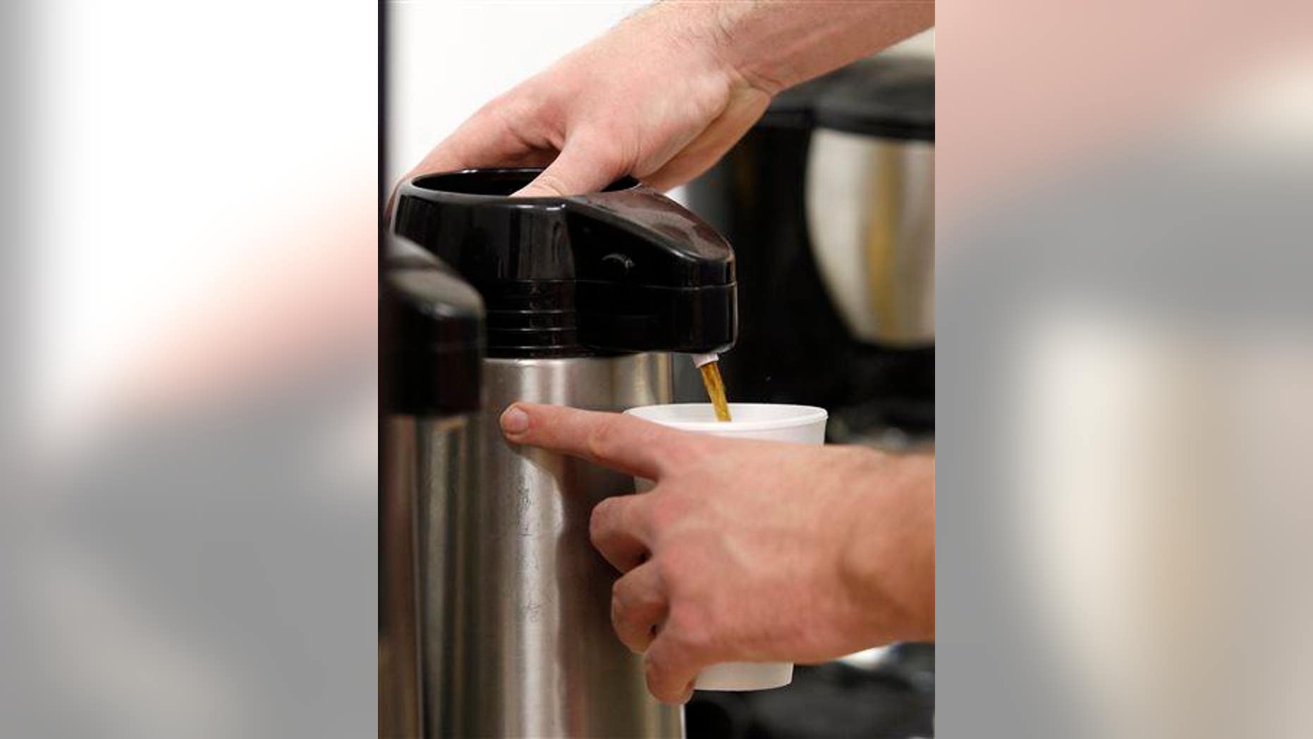 A man fills a cup with coffee at the East Daily Grind in Waterloo, Iowa, Thursday, Feb. 12, 2015.