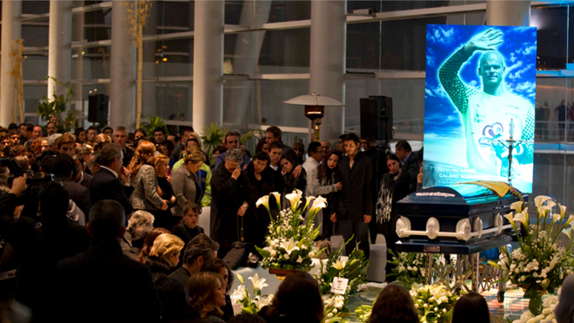 People attend the wake of Colombia's former goalkeeper Miguel Calero in Pachuca, Mexico, Tuesday, Dec. 4, 2012. Calero died on Tuesday after suffering a stroke on Nov. 25. (AP Photo/Eduardo Verdugo)